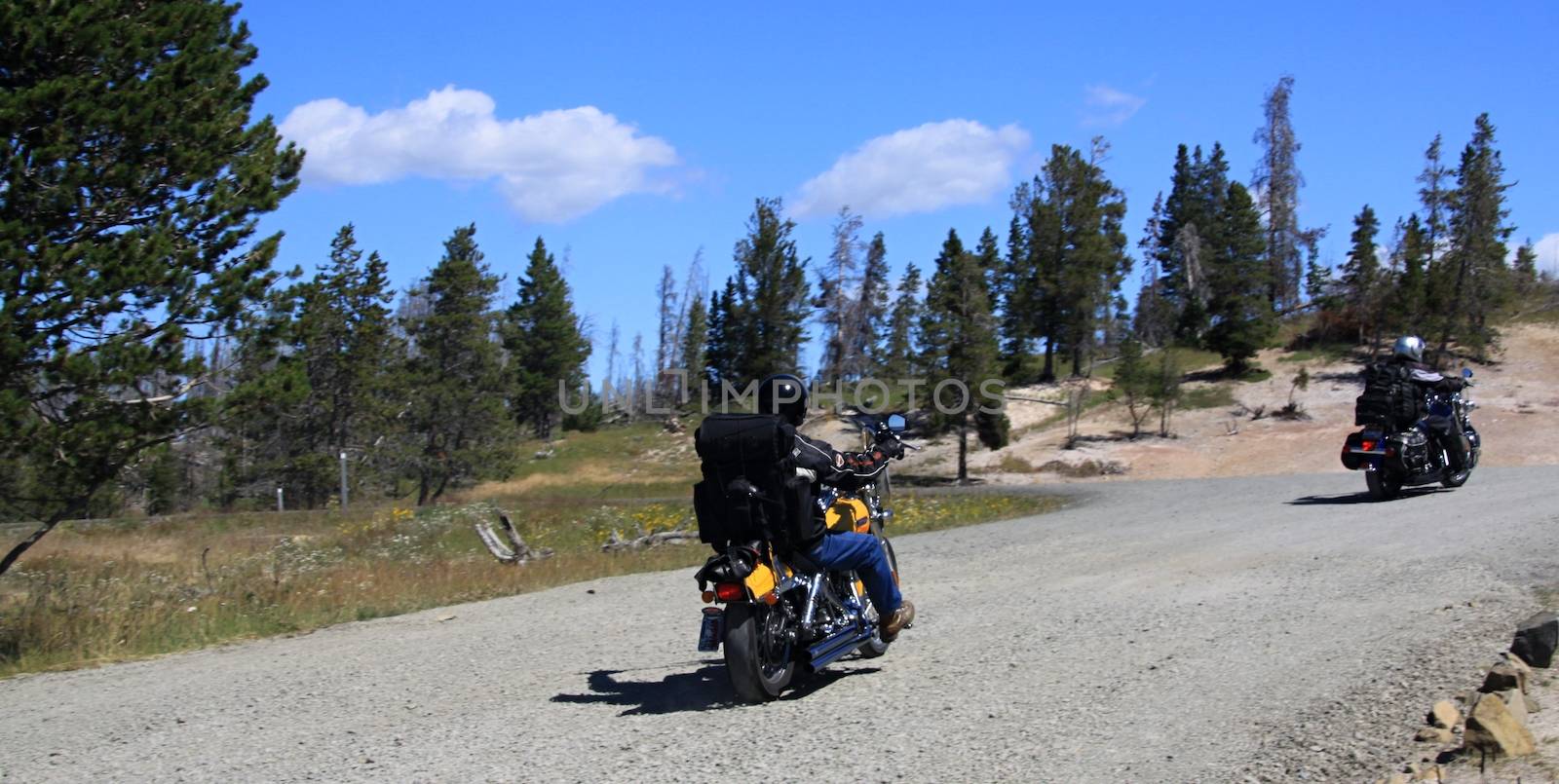 Two moto bikers on mountainous highway in Yellowstone national park