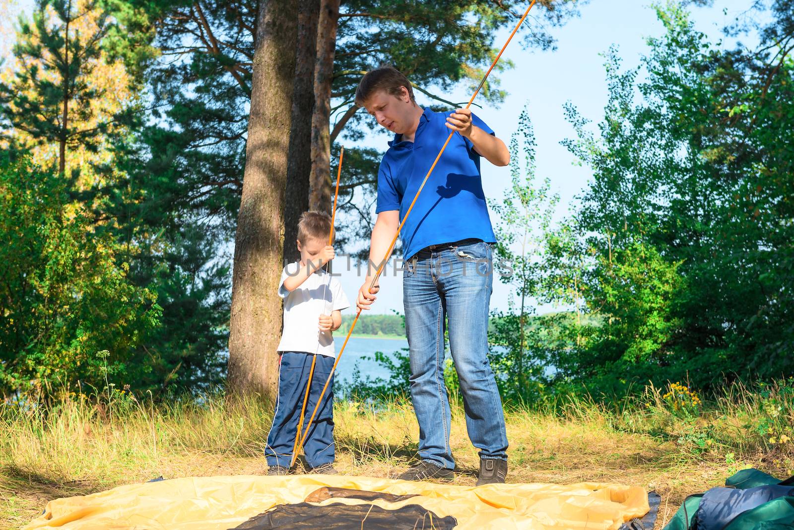 father and son put a tent in the camping by kosmsos111