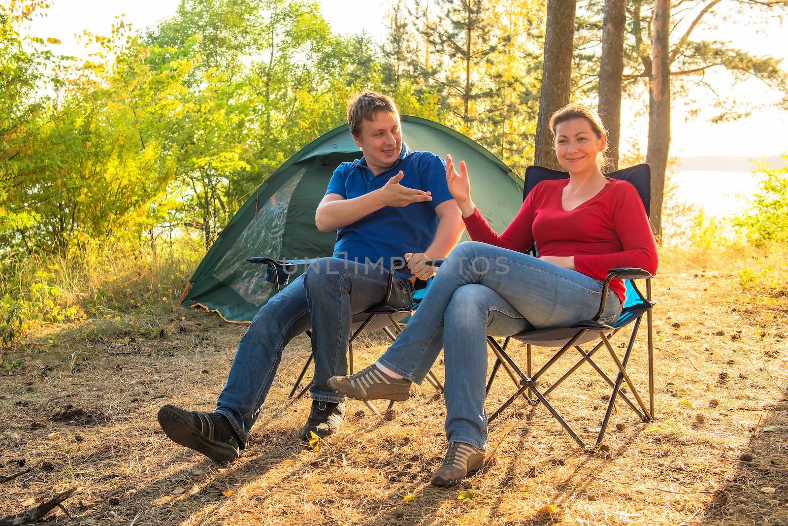 couple talking on a camping holiday by kosmsos111
