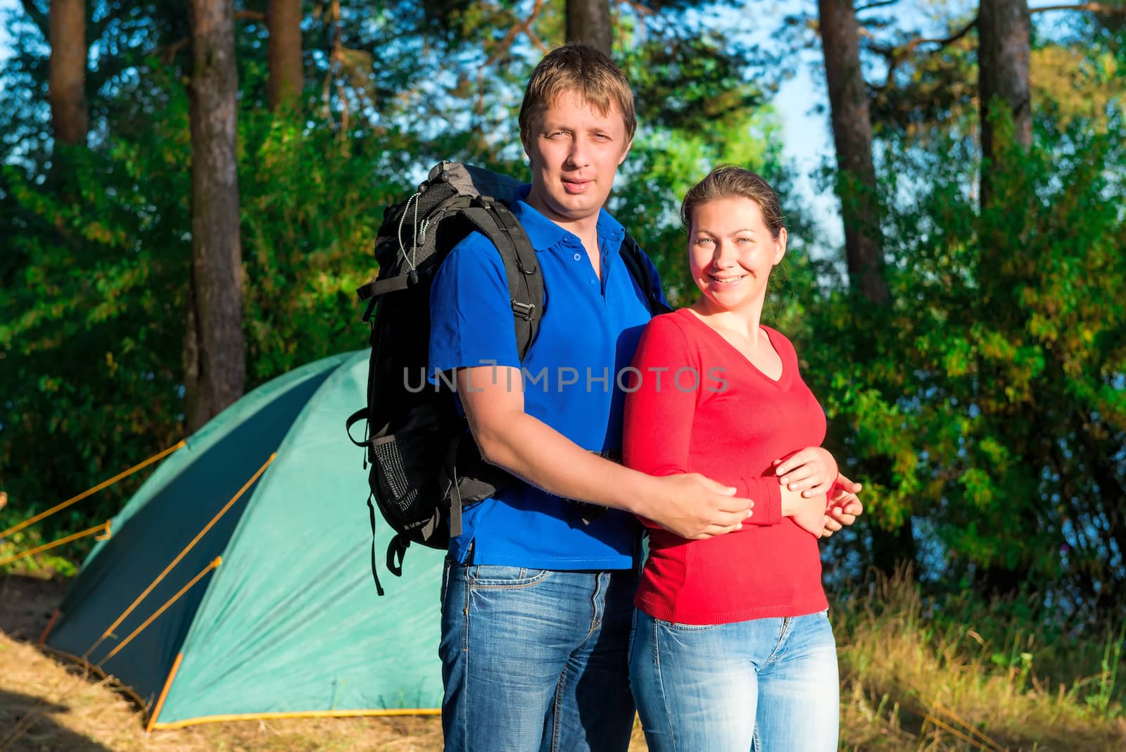 portrait of a beautiful couple next to the tent