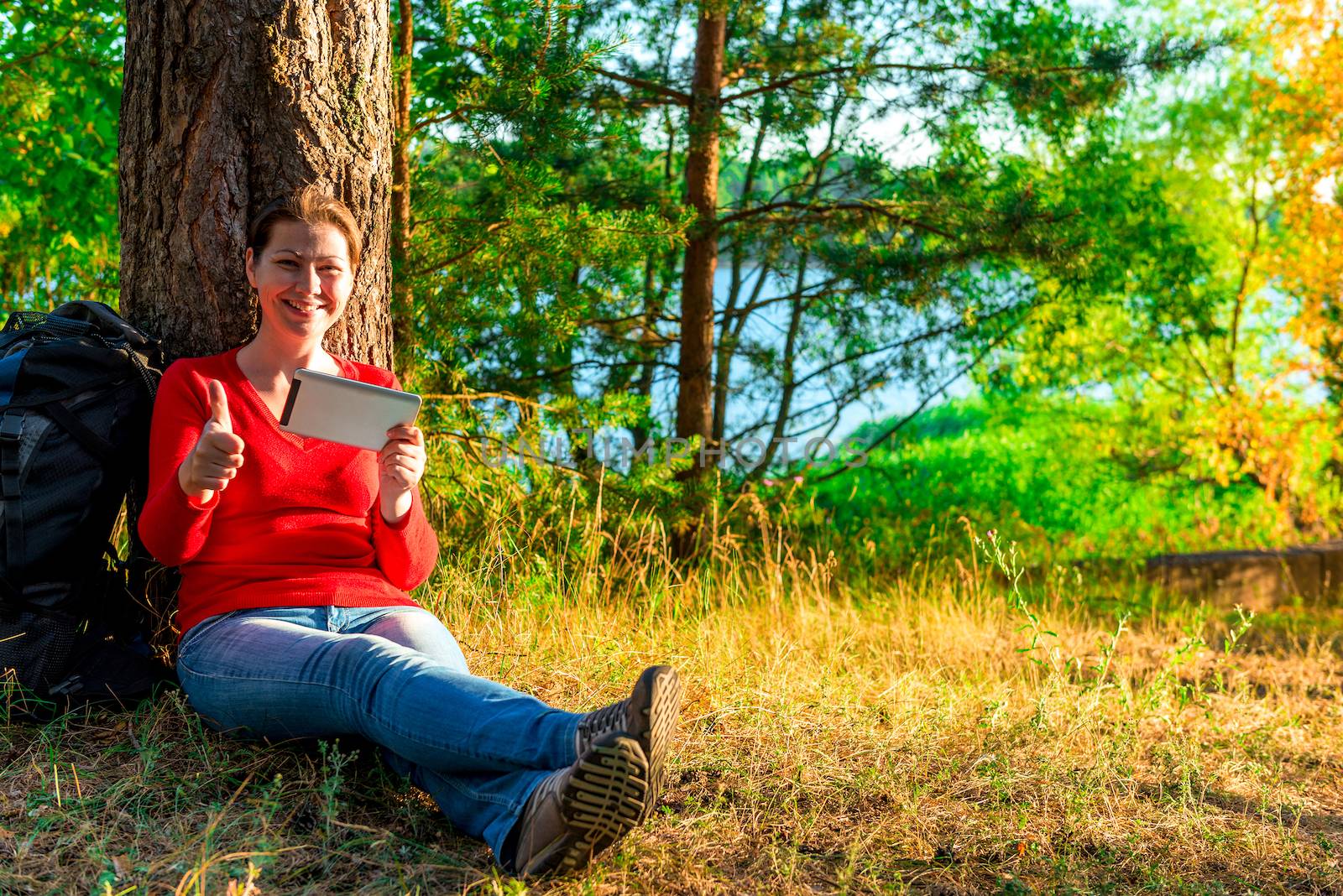 girl with a backpack relaxing in nature