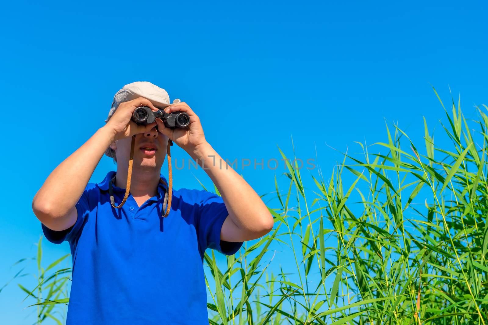 young hunter looking through binoculars