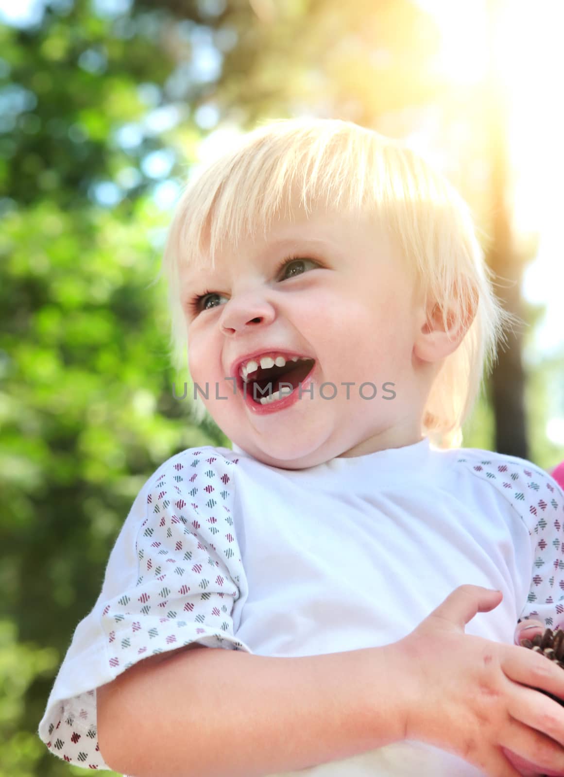 Happy Baby Boy laughing at the Summer Park