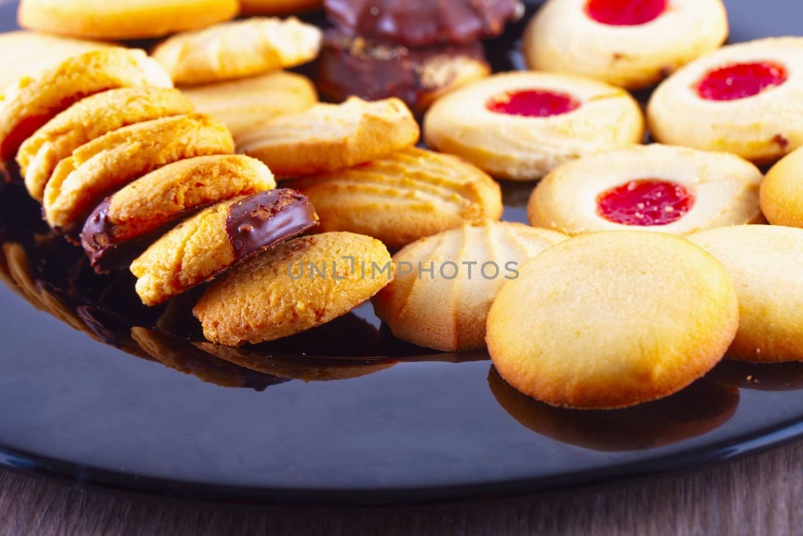 Biscuits of various kinds over a black plate