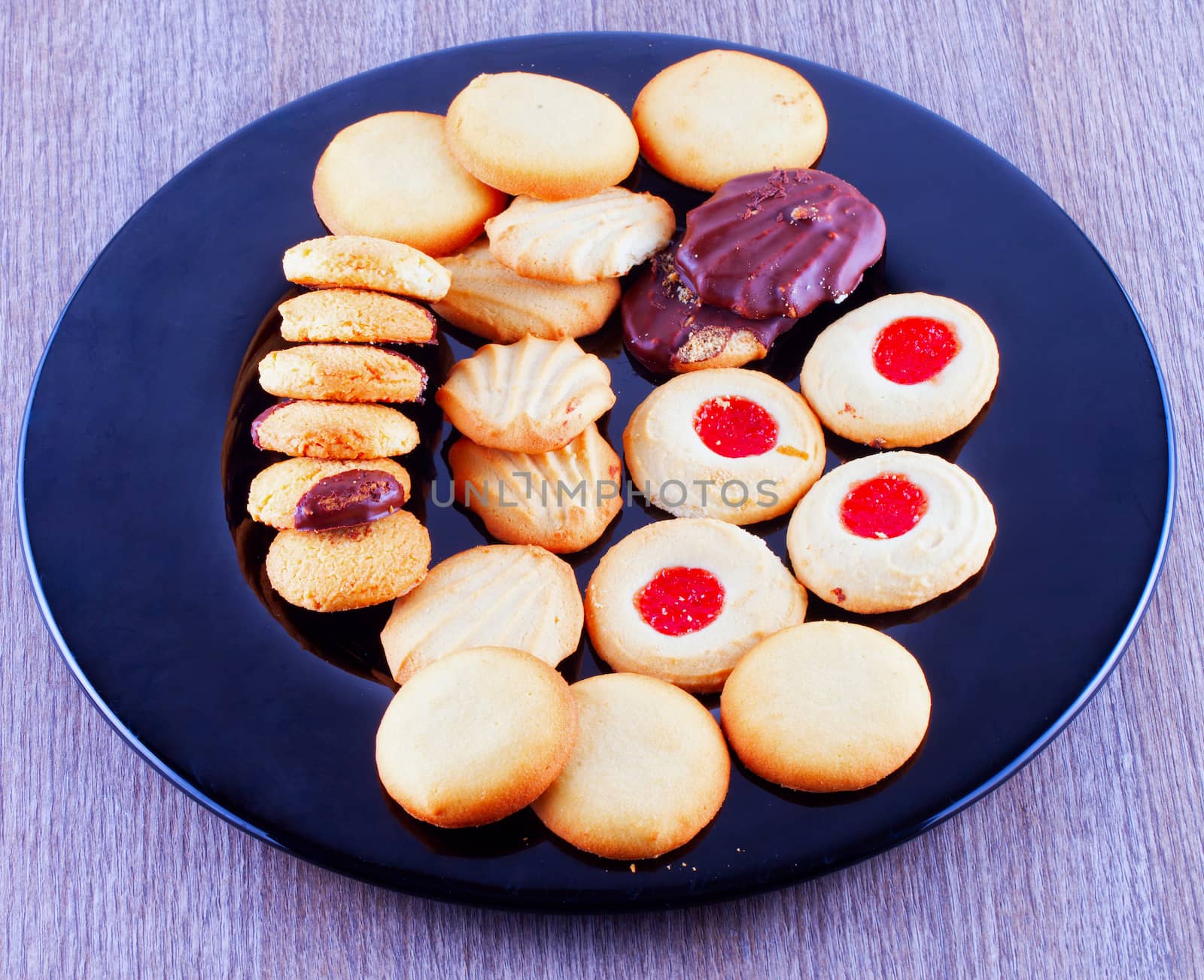 Biscuits of various kinds over a black plate