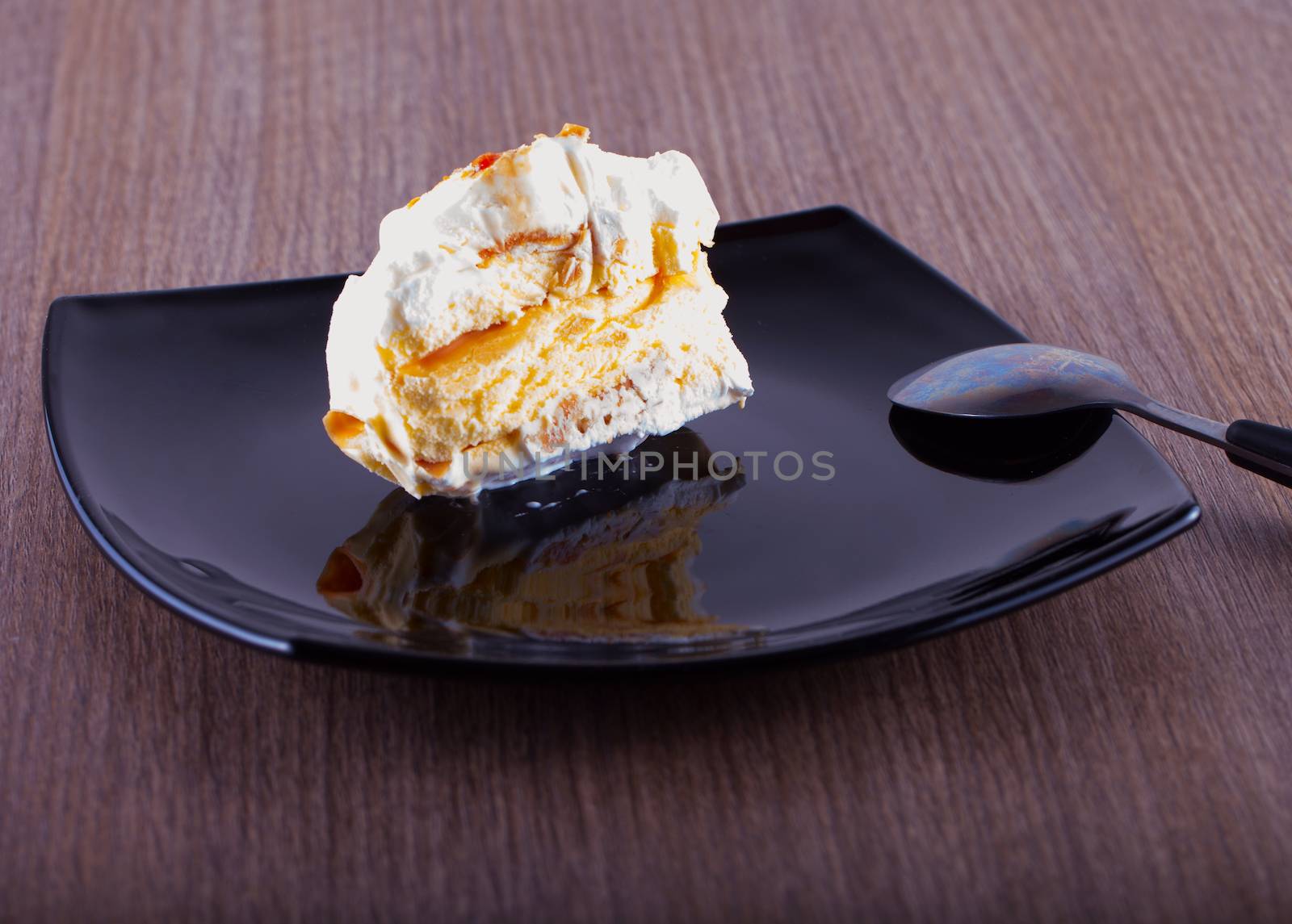 Ice cream cake over a black reflecting plate