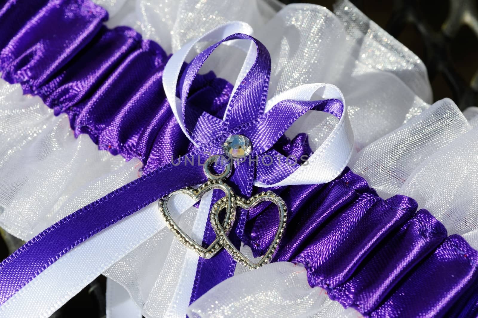 Brides purple and white garter macro detail on wedding day