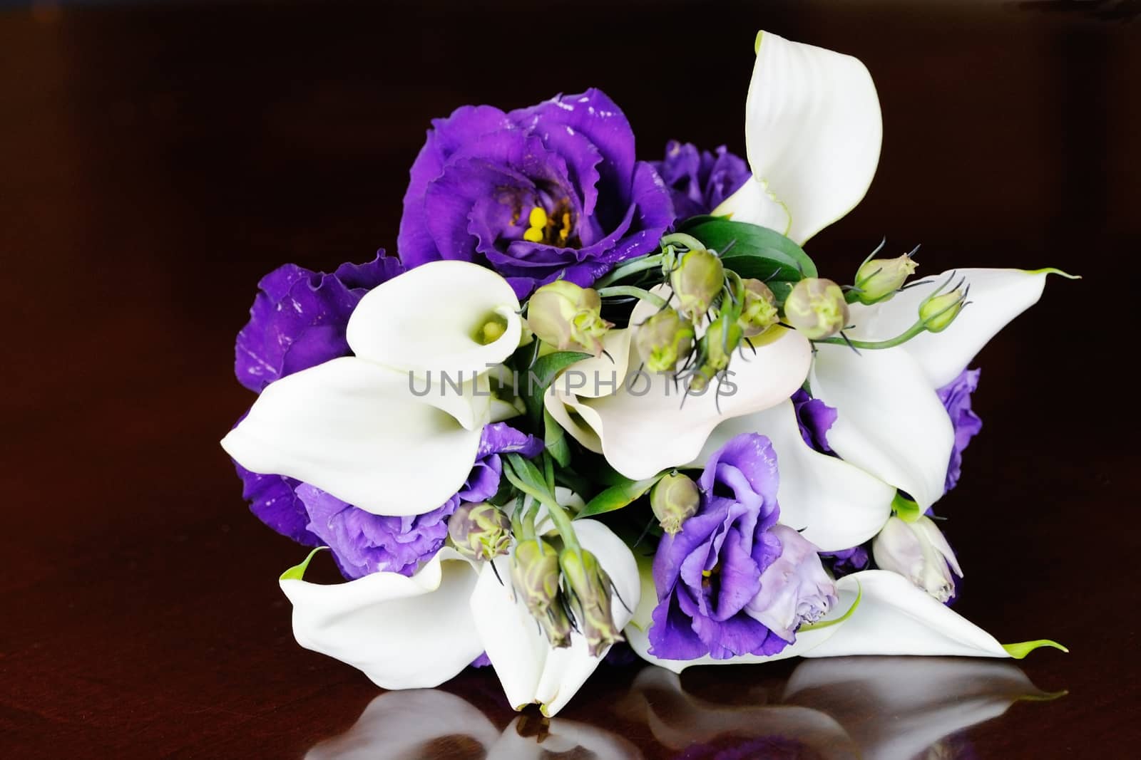 Brides purple and white bouquet on wedding day