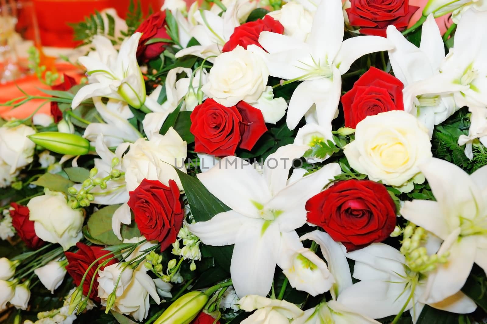 Brides bouquet of red and white roses and lillies