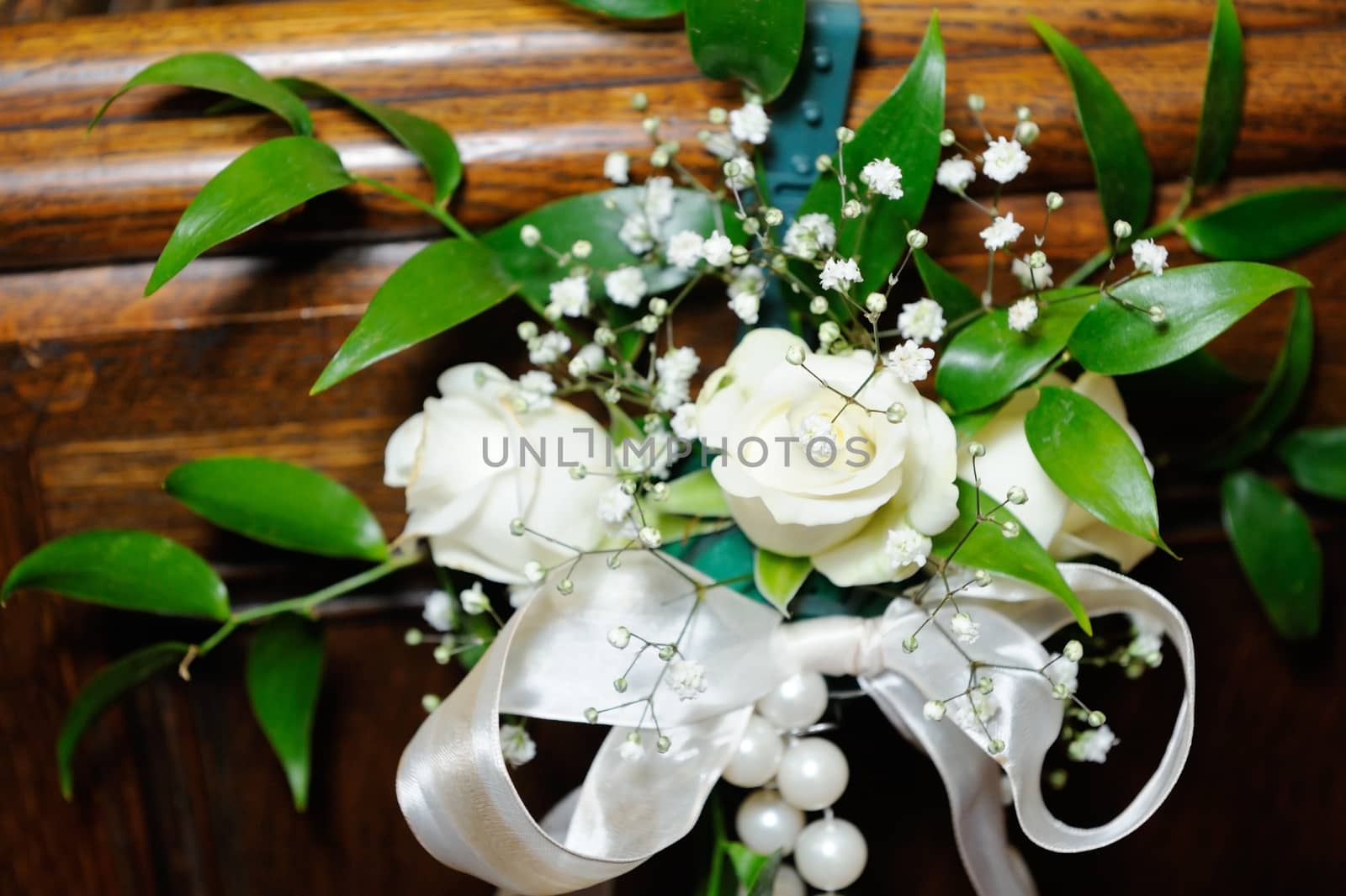 White roses decorate inside of a church on wedding day