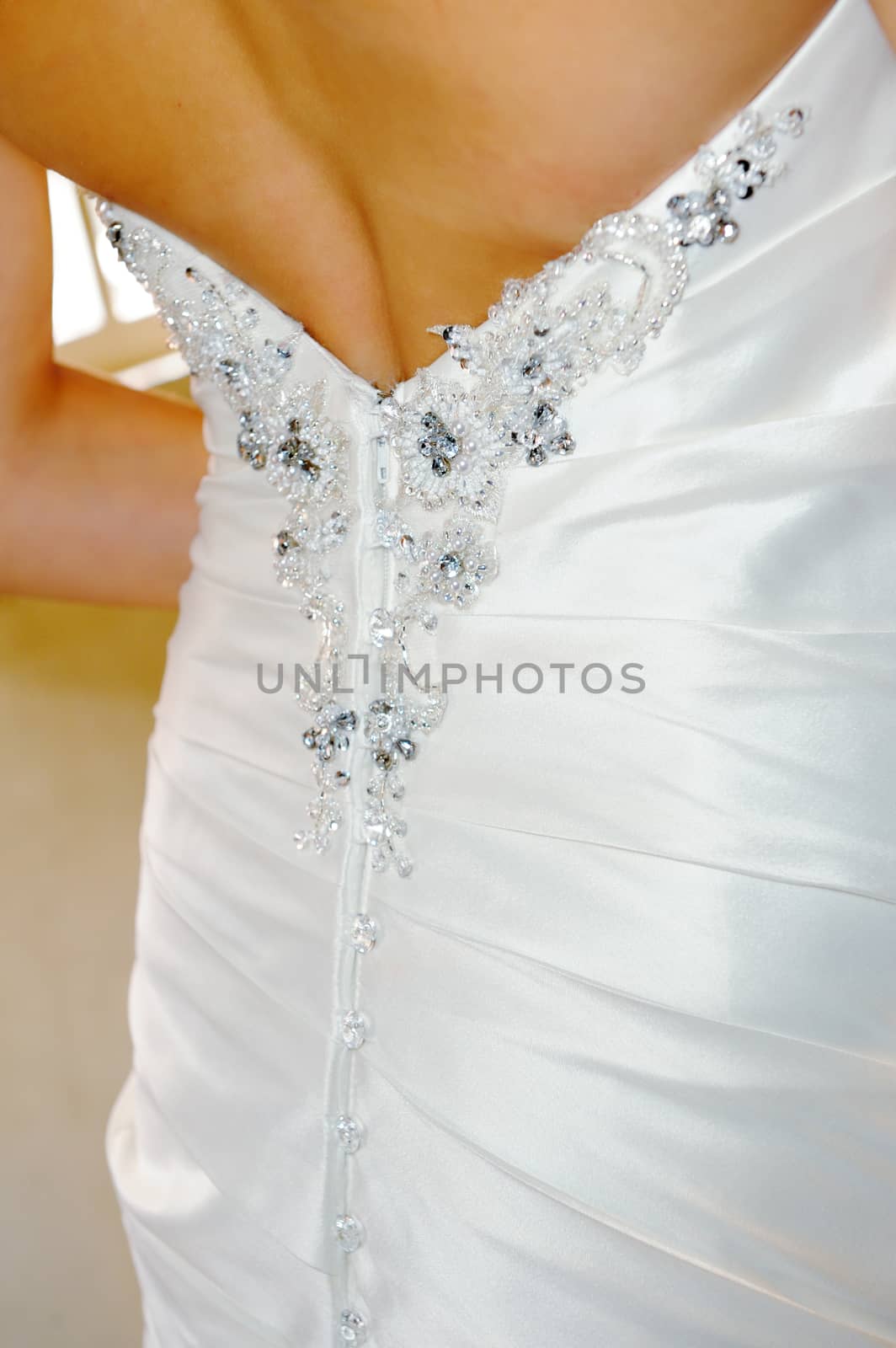 Closeup of back of brides dress on wedding day
