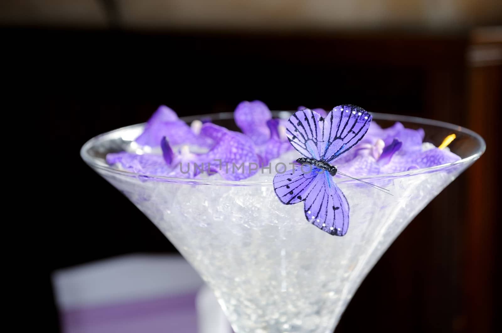 Purple butterfly and petals decorate wedding reception