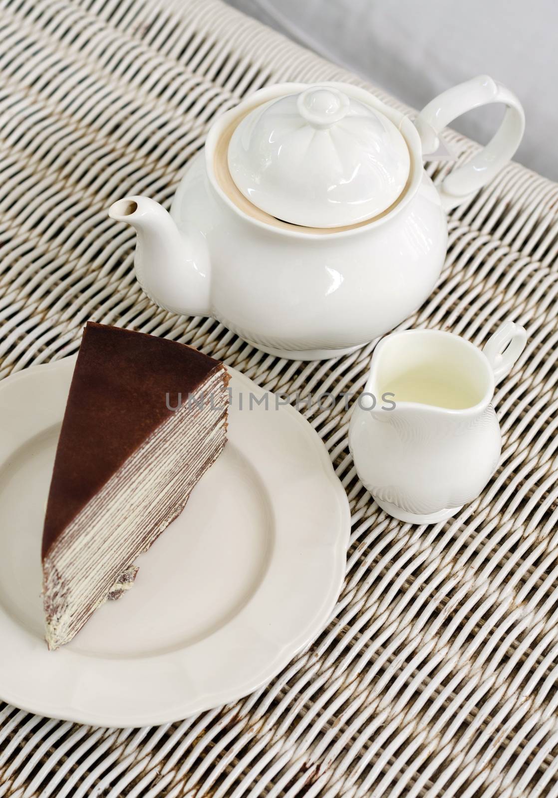 Afternoon tea with chocolate crape cake on weave texture