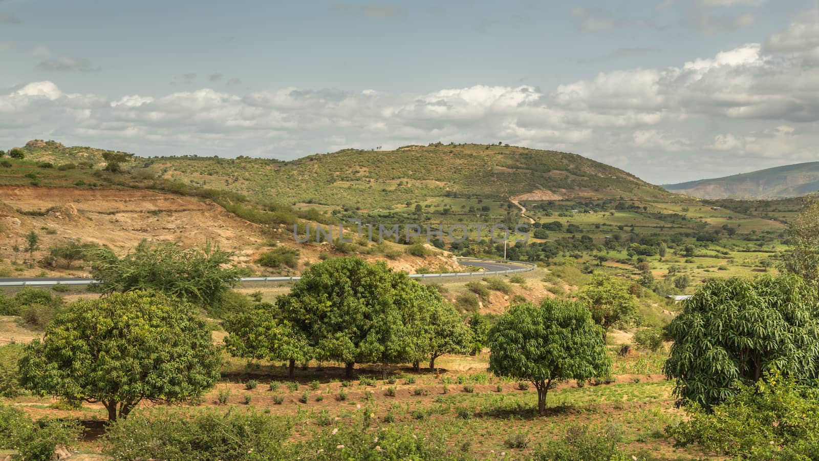 The road from Harar to Jigjiga cutting through a beautiful landscape with lush greenery surrounded by mountains