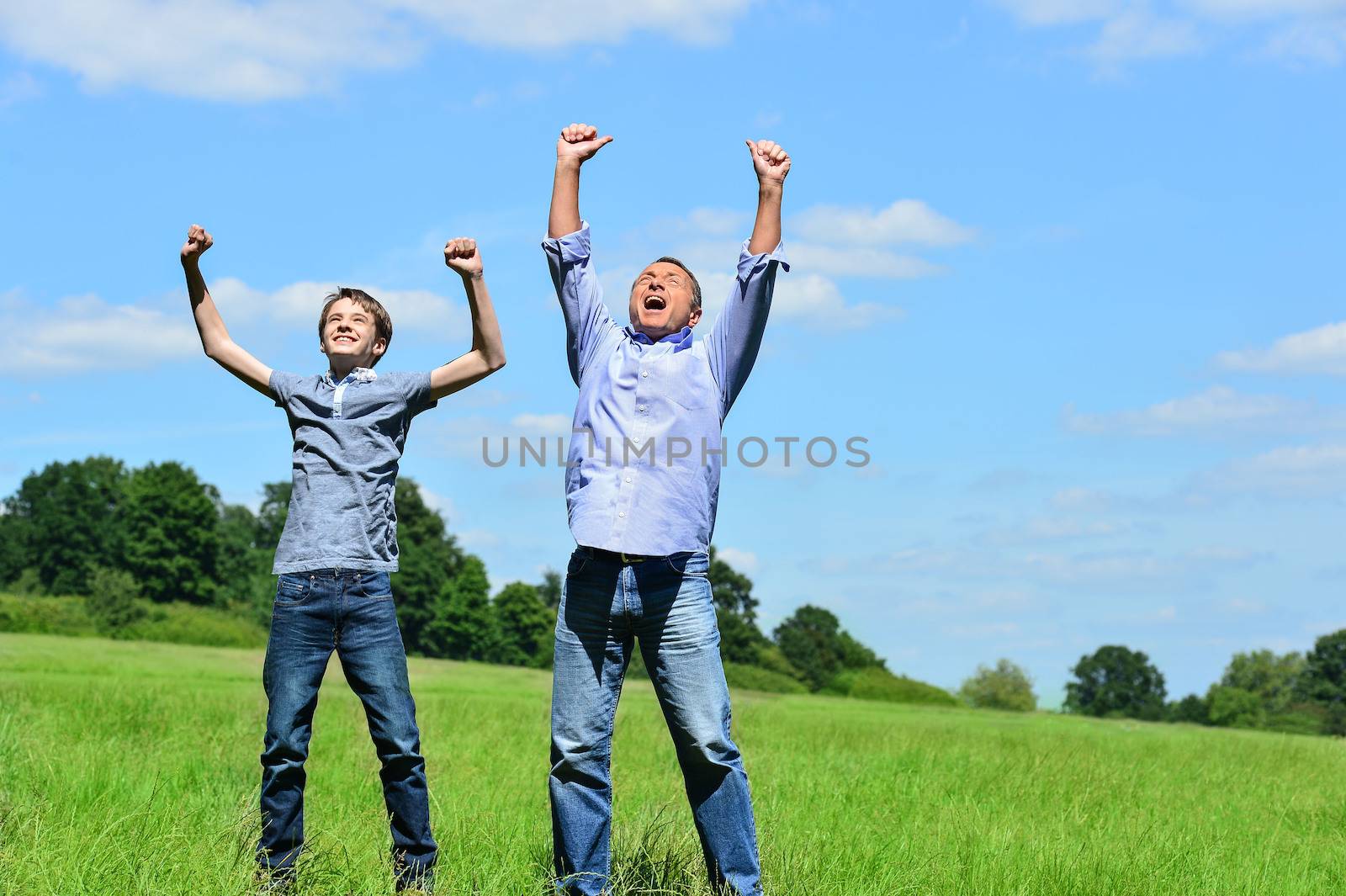 Enthusiastic father and son outdoors by stockyimages