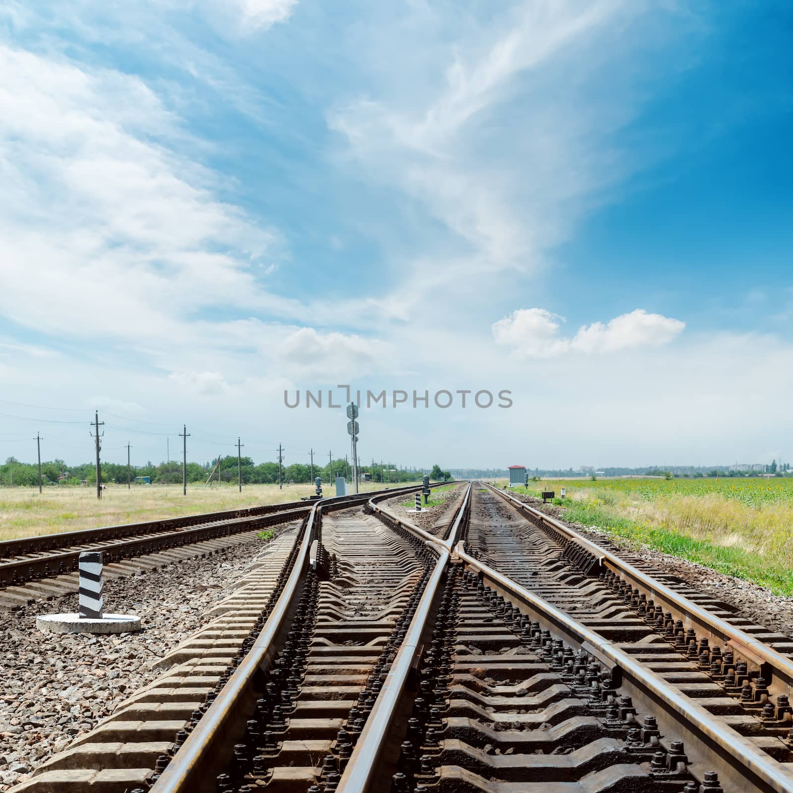 crossing of railroad under cloudy sky by mycola