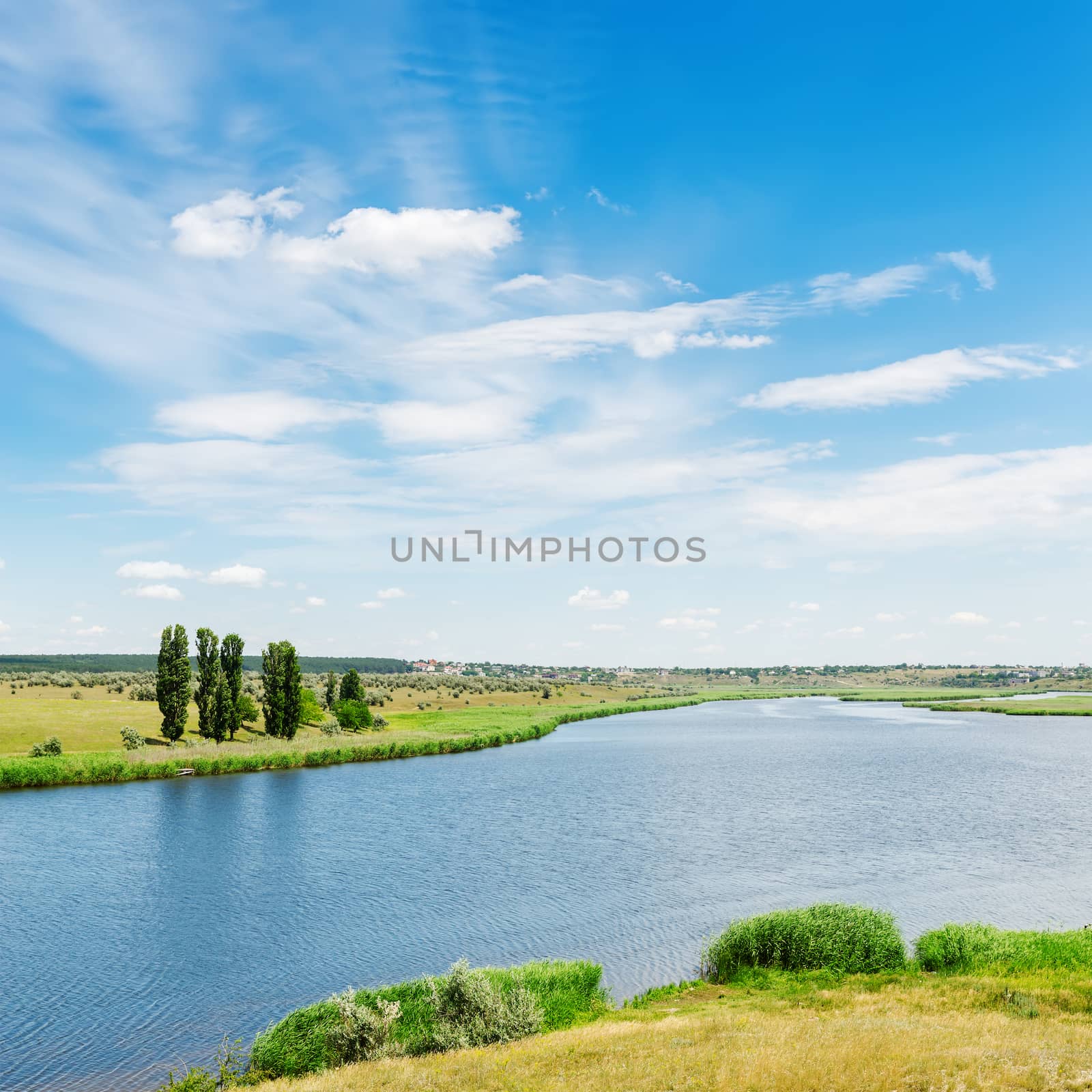 view to landscape with river and clouds in blue sky by mycola