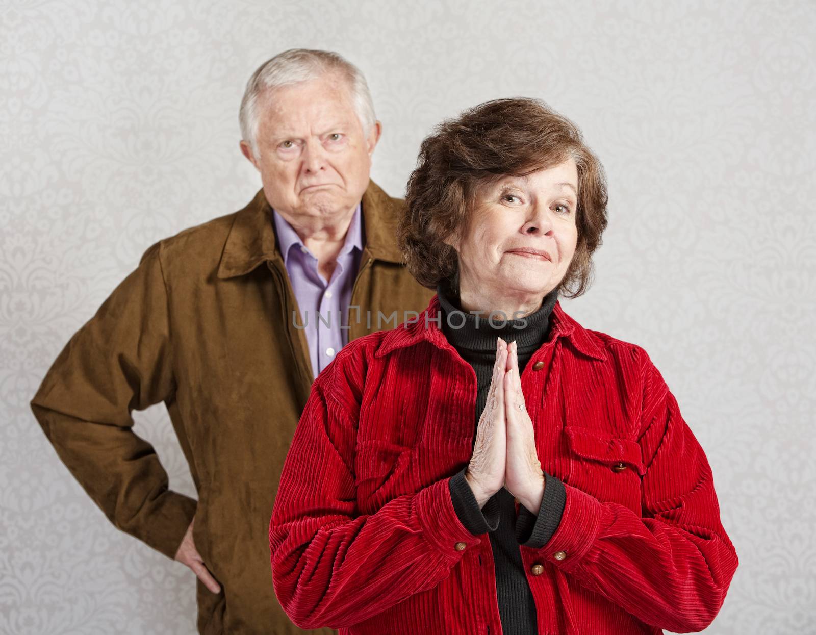 Grumpy old man behind beautiful innocent lady