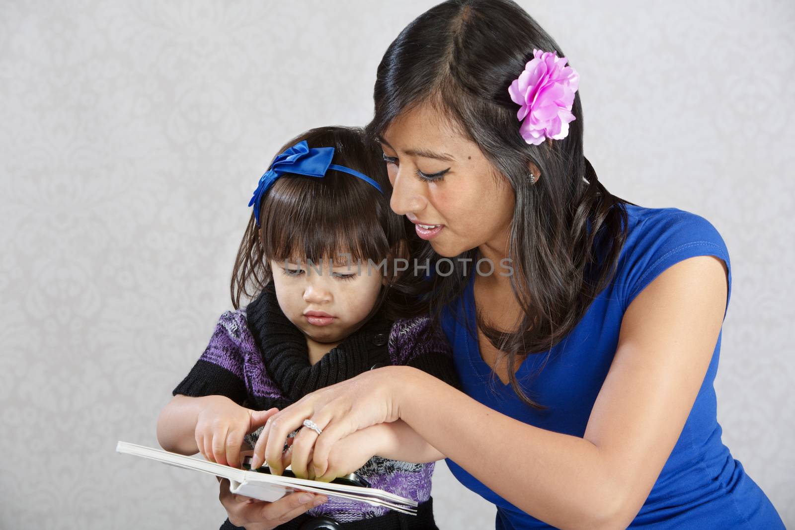 Mother Reading to Child by Creatista