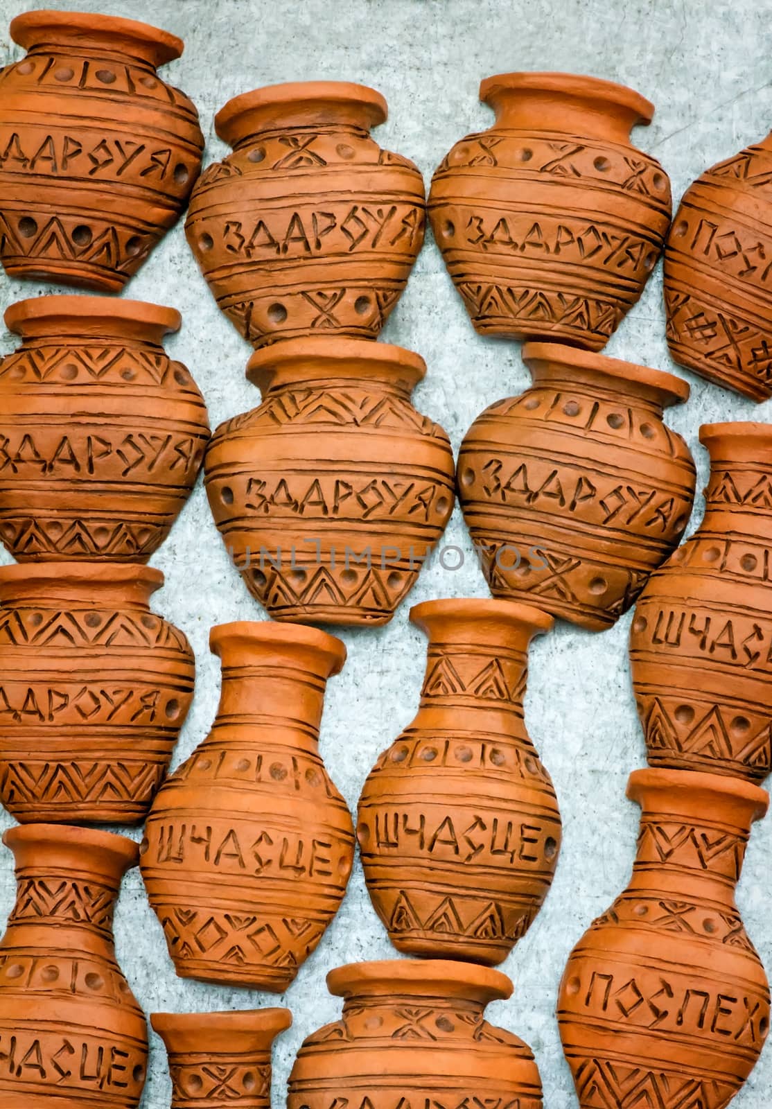 The souvenirs imitating clay jugs with inscriptions: health, happiness, success.