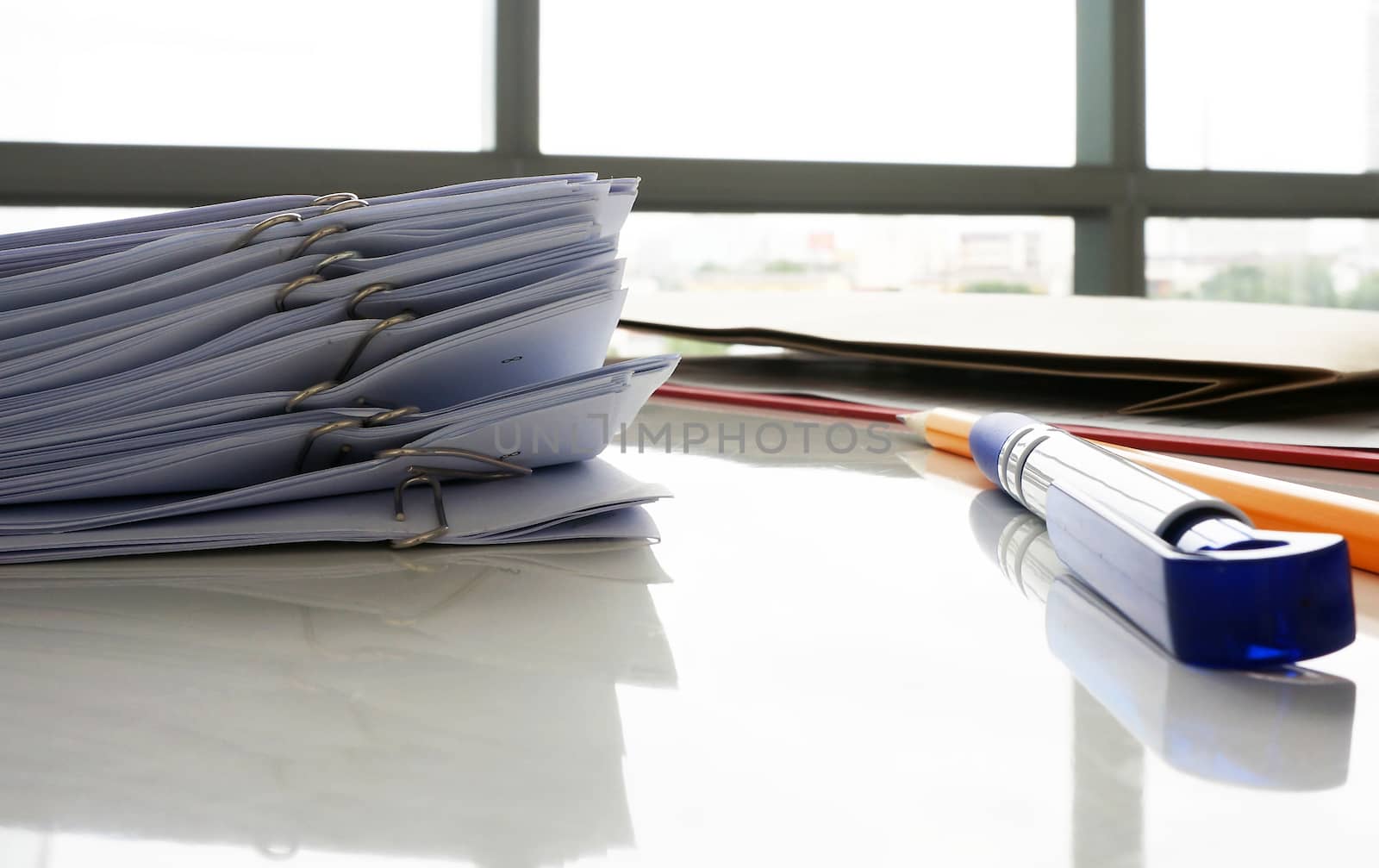 Documents prepared for the boss. Case for paper, board with pen and pencil placed on a desk.                            