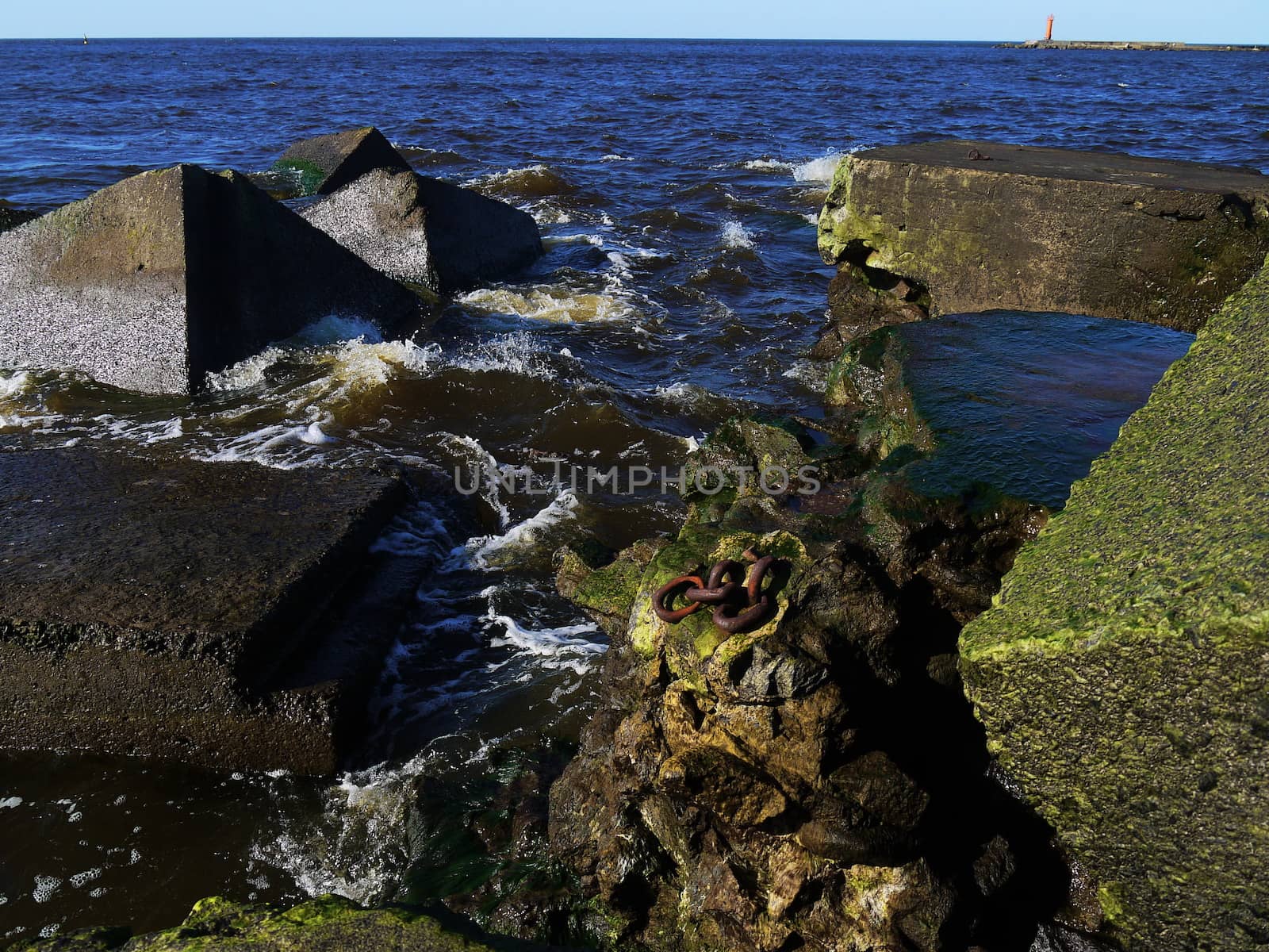 Clear sea water and the big stones surrounded with waves