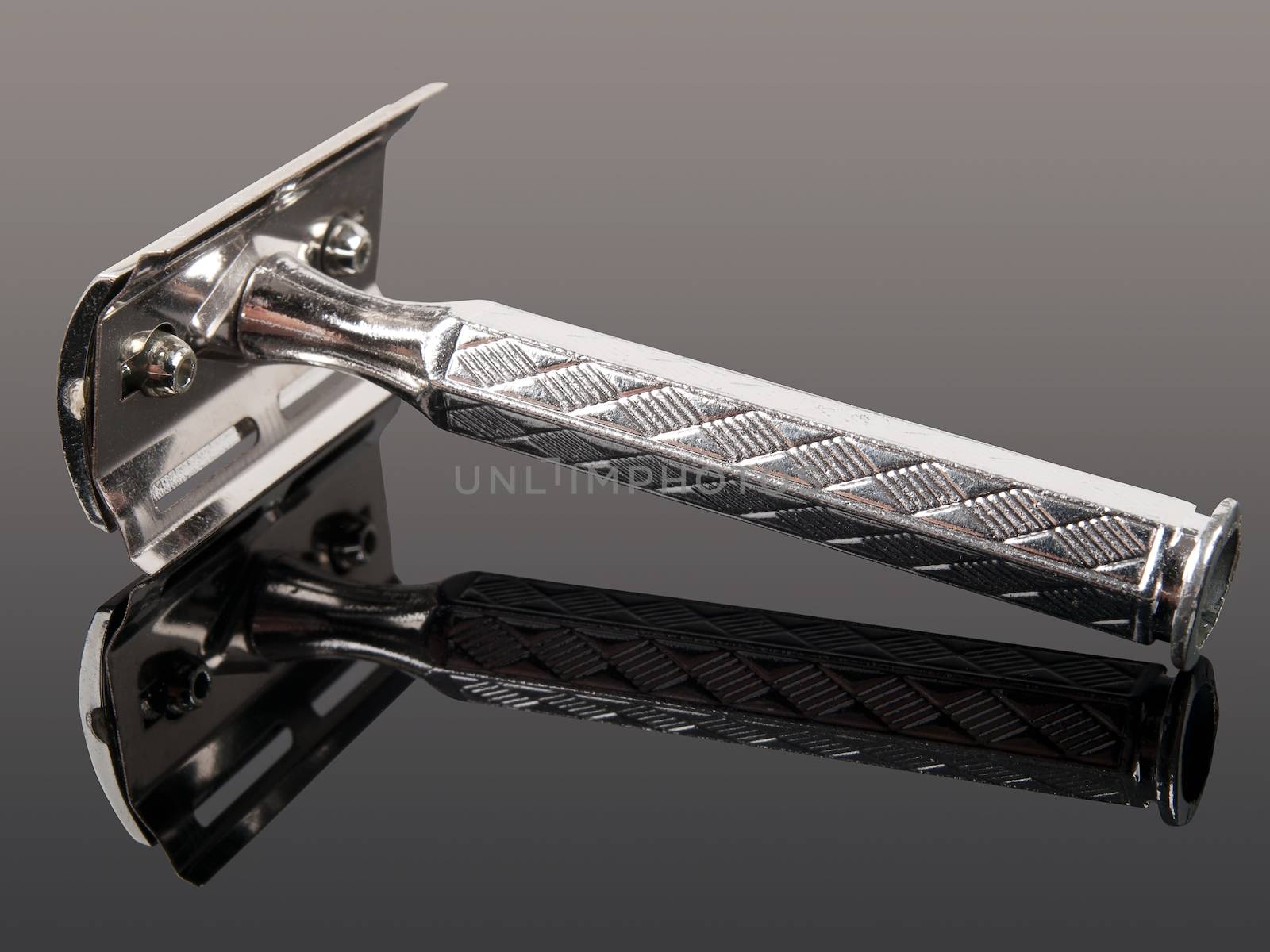 vintage razor with reflection isolated on gray background