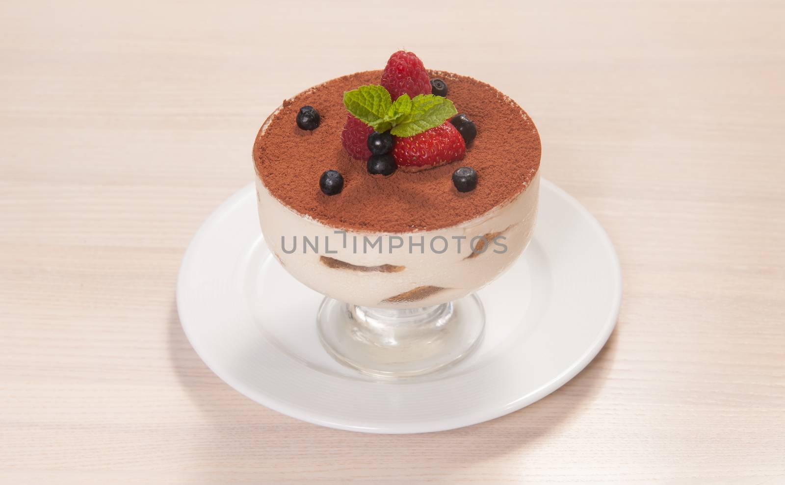 Tiramisu cake in glass with small fruits by lipik