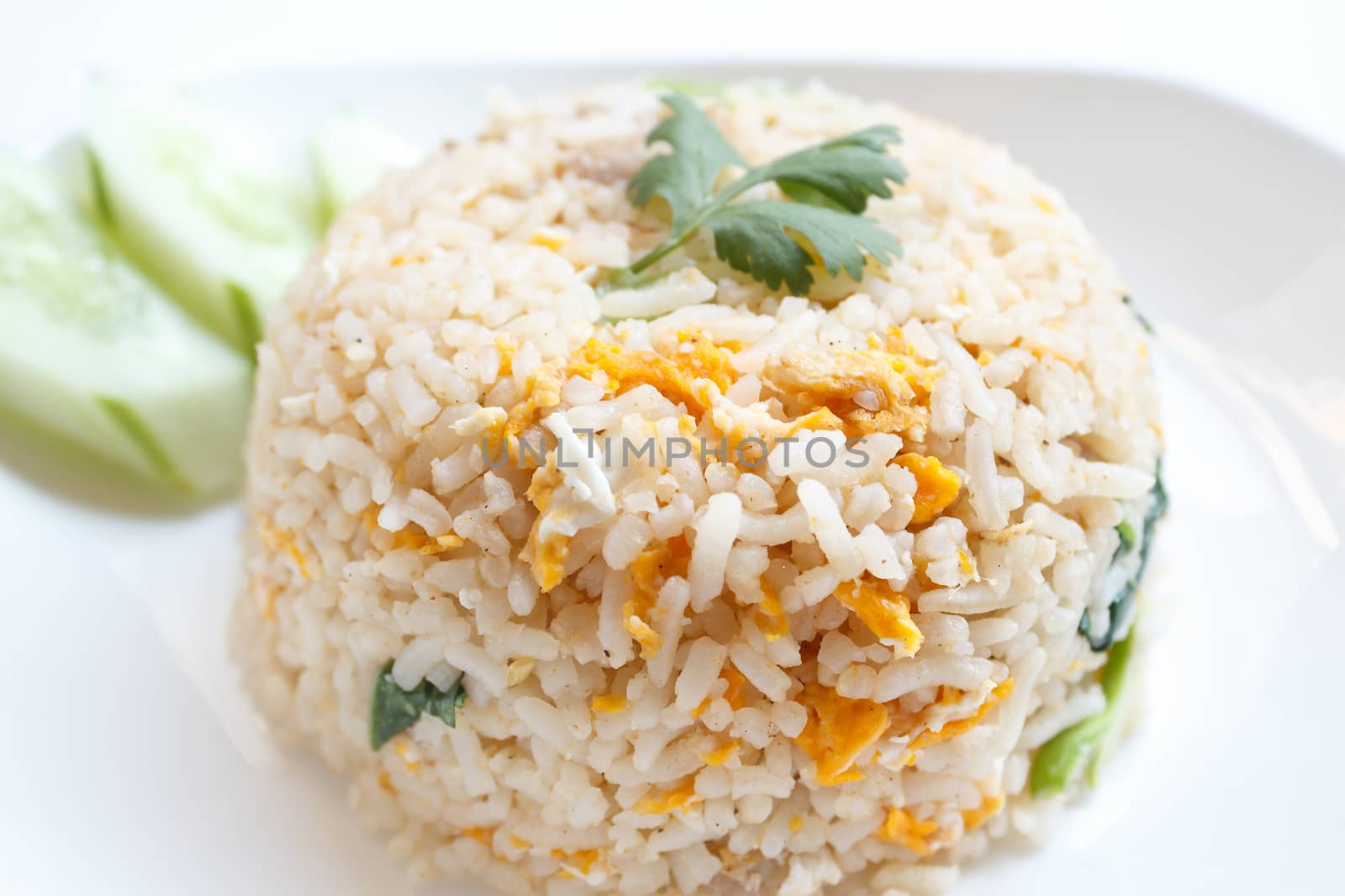 fried rice with pork and cucumber garnish in Asia