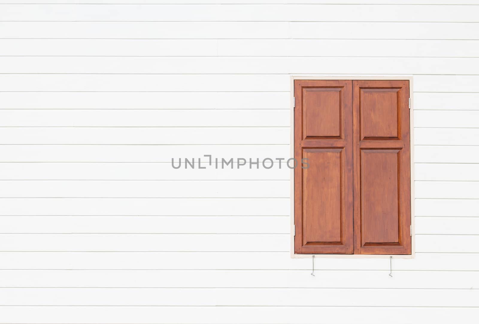 brown window on white wooden wall by vitawin