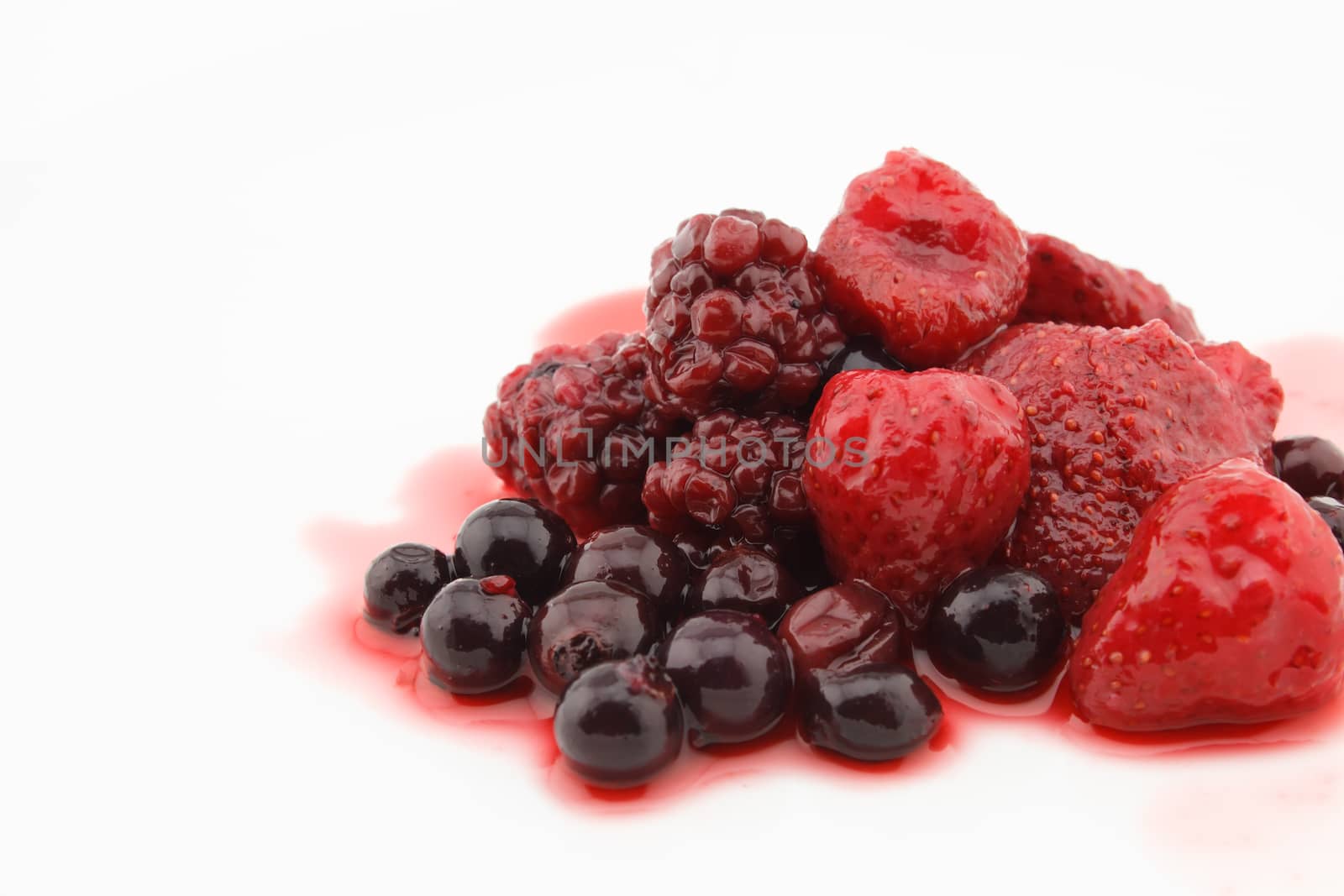 Strawberries, blueberries and raspberries with syrup  isolated on White Background