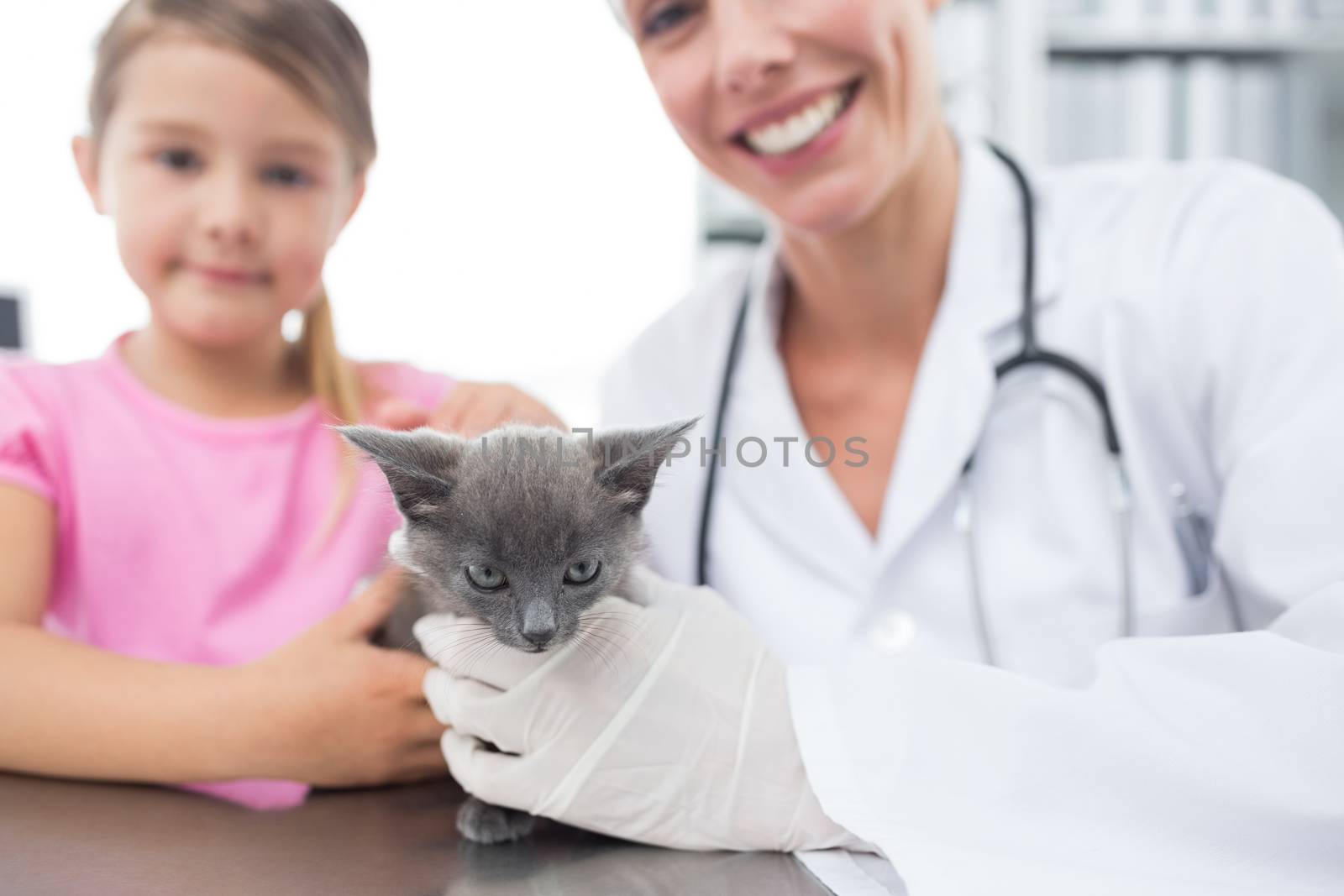 Veterinary and girl with kitten in hospital by Wavebreakmedia