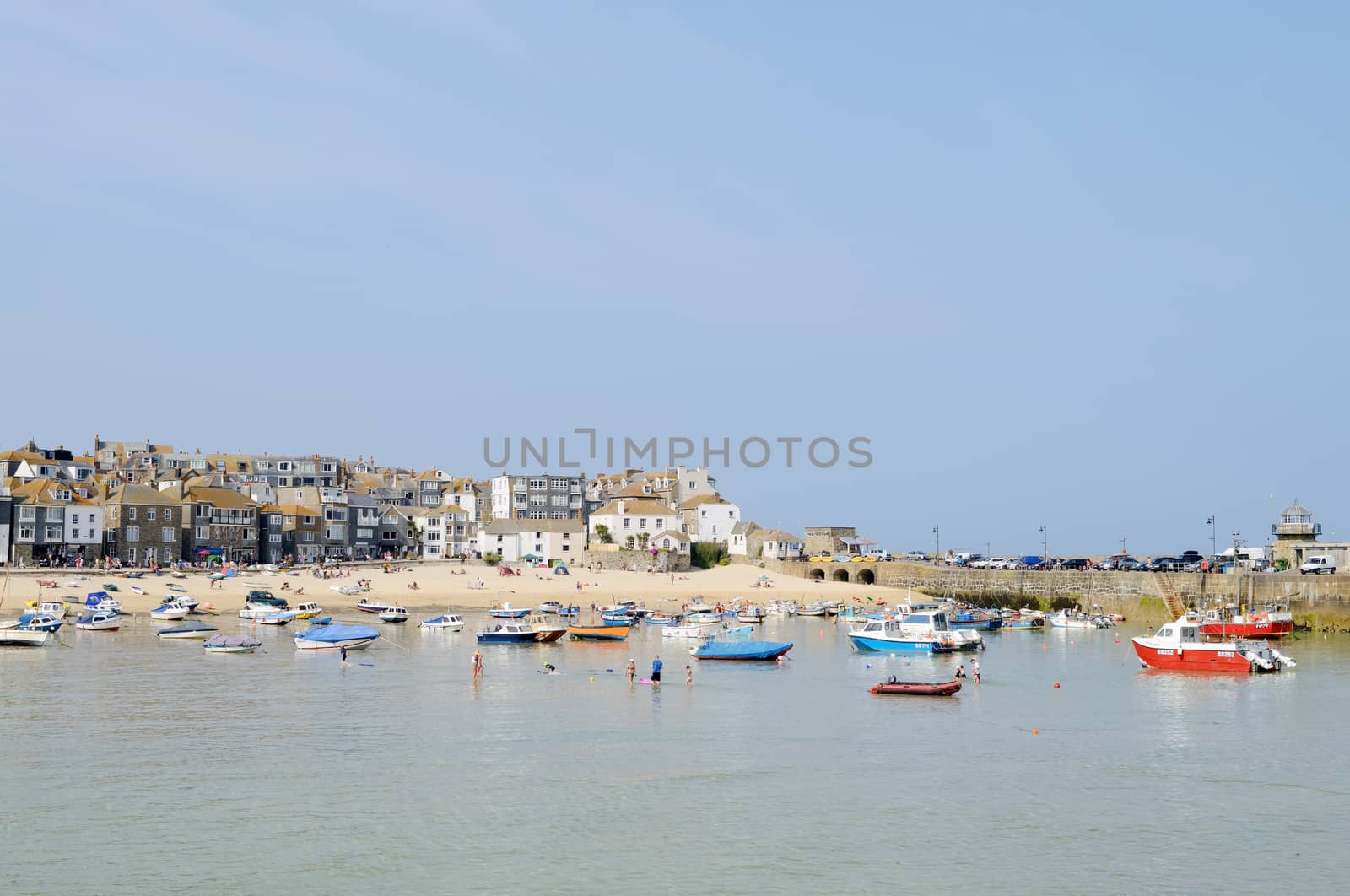 St Ives in Cornwall, England. By the beach boats in harbour on a sunny day.