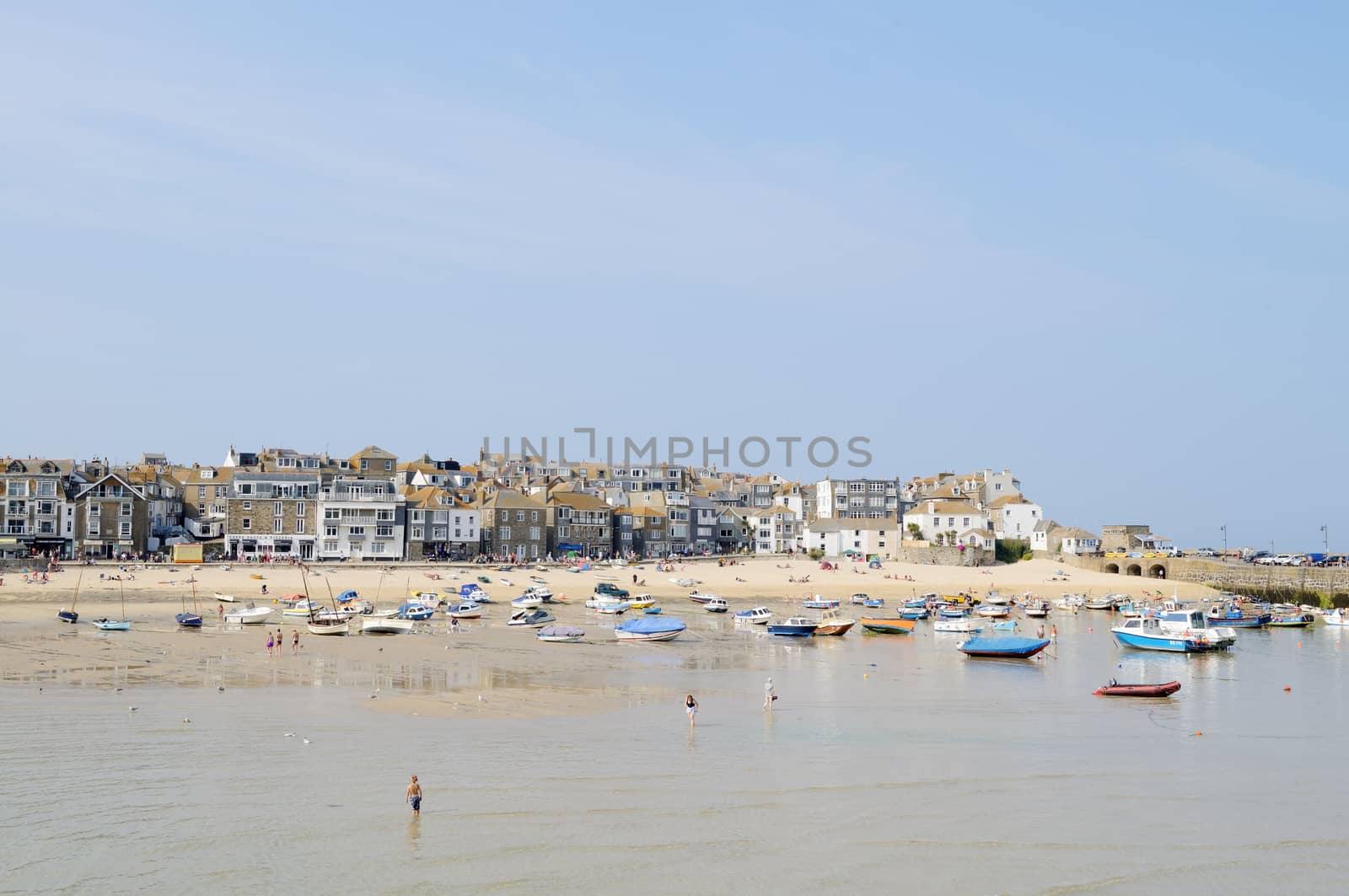 St Ives in Cornwall in the summer on a sunny day showing the beach and boats