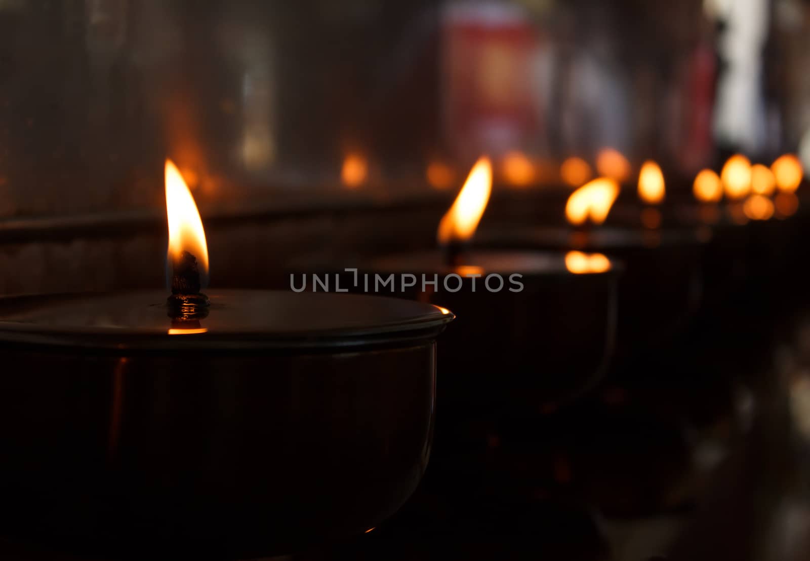 Burning candles in Thai buddhist temple