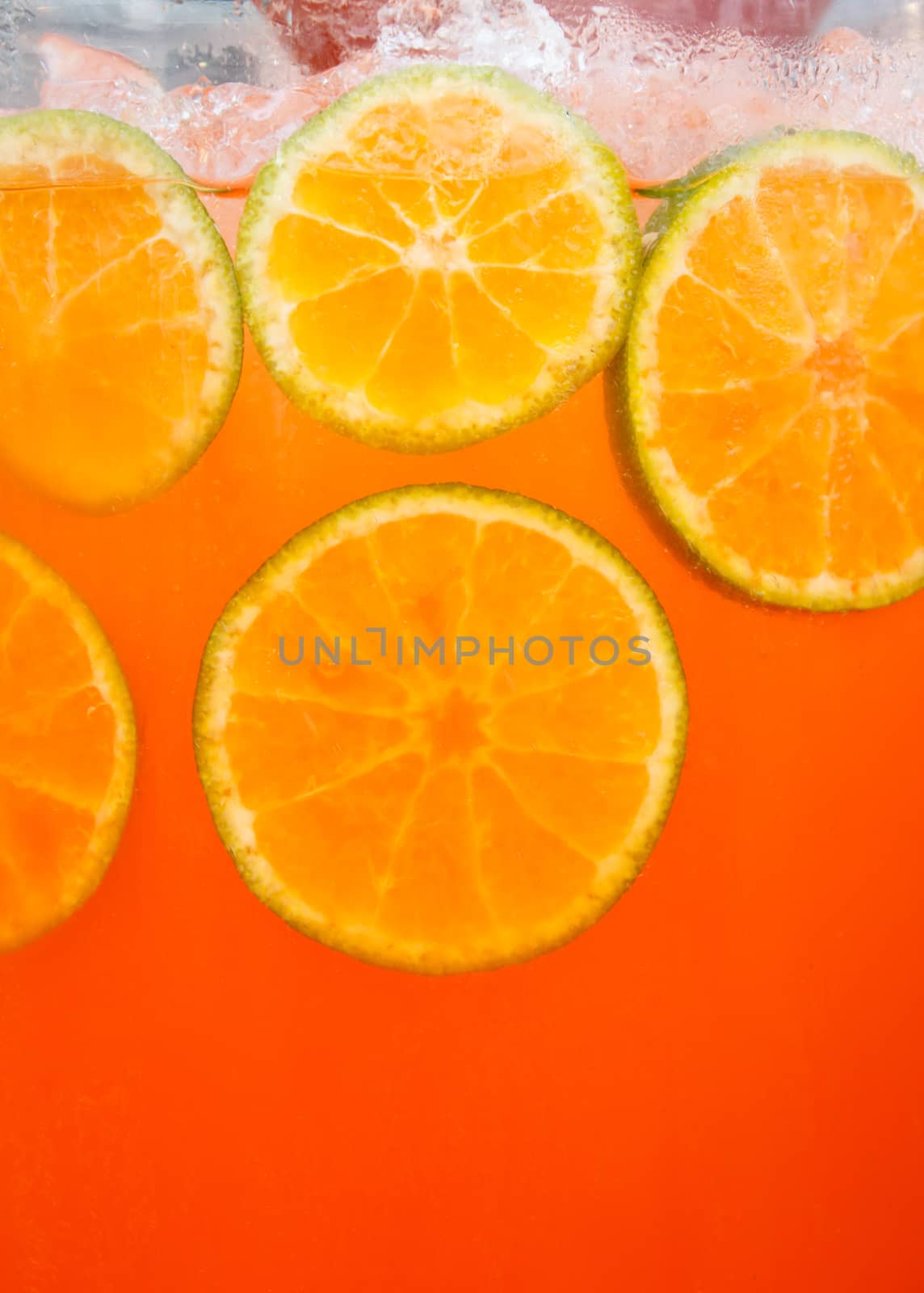 Closeup Sliced orange in glass of orange juice  by vitawin