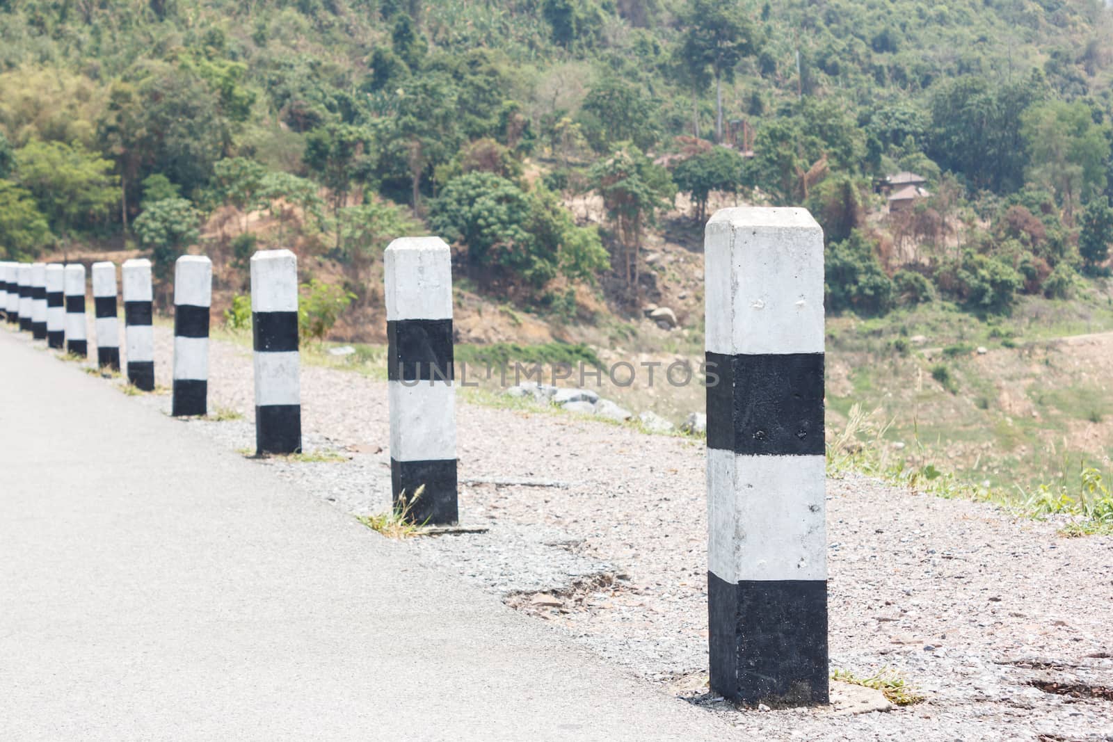 Black and white pole symbols traffic on road