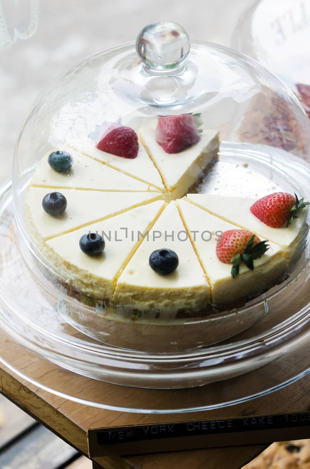 Strawberry and Blueberry cheesecake on cake stand 