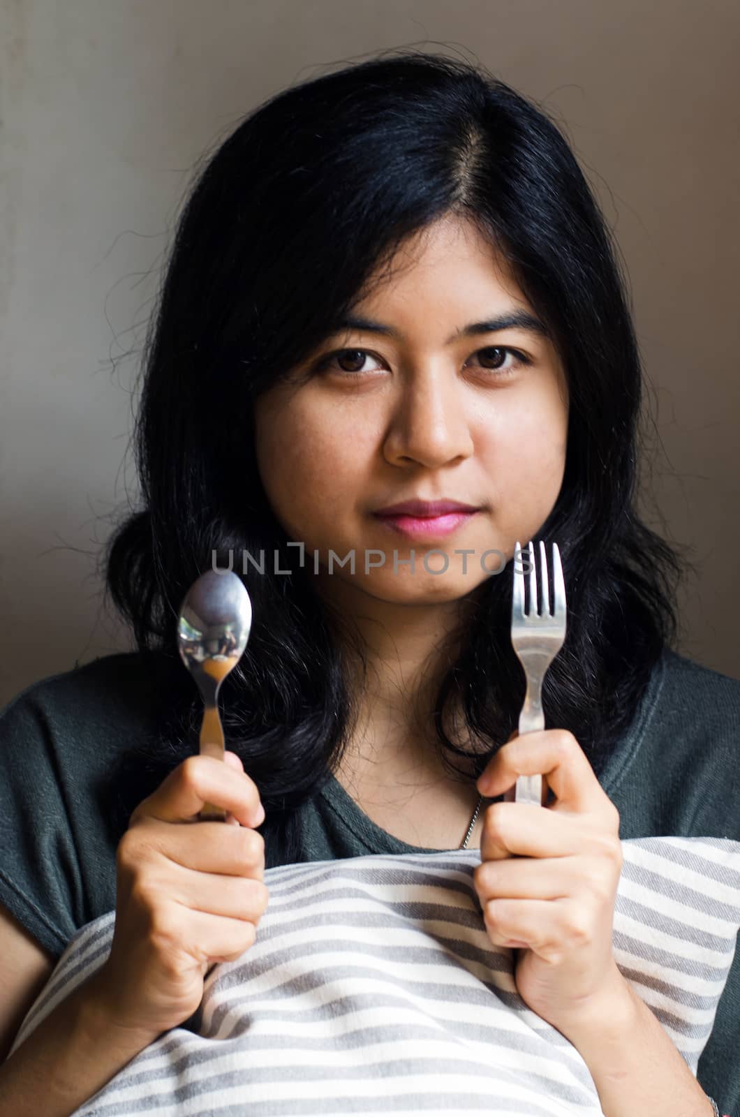 Woman with spoon and fork by siraanamwong