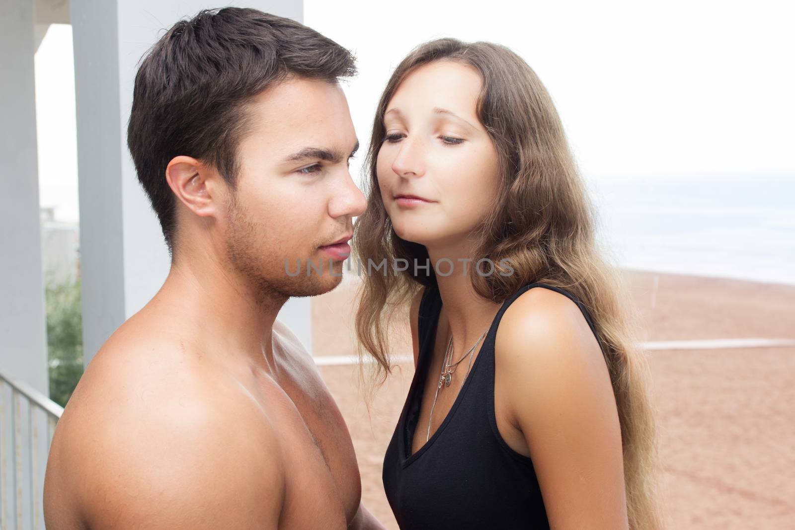 Summer, sea. Attractive couple on the beach