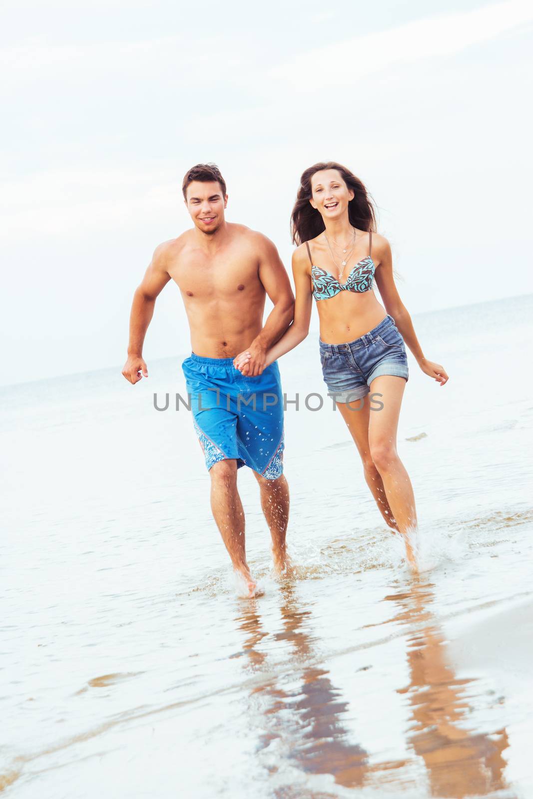 Summer, sea. Attractive couple on the beach