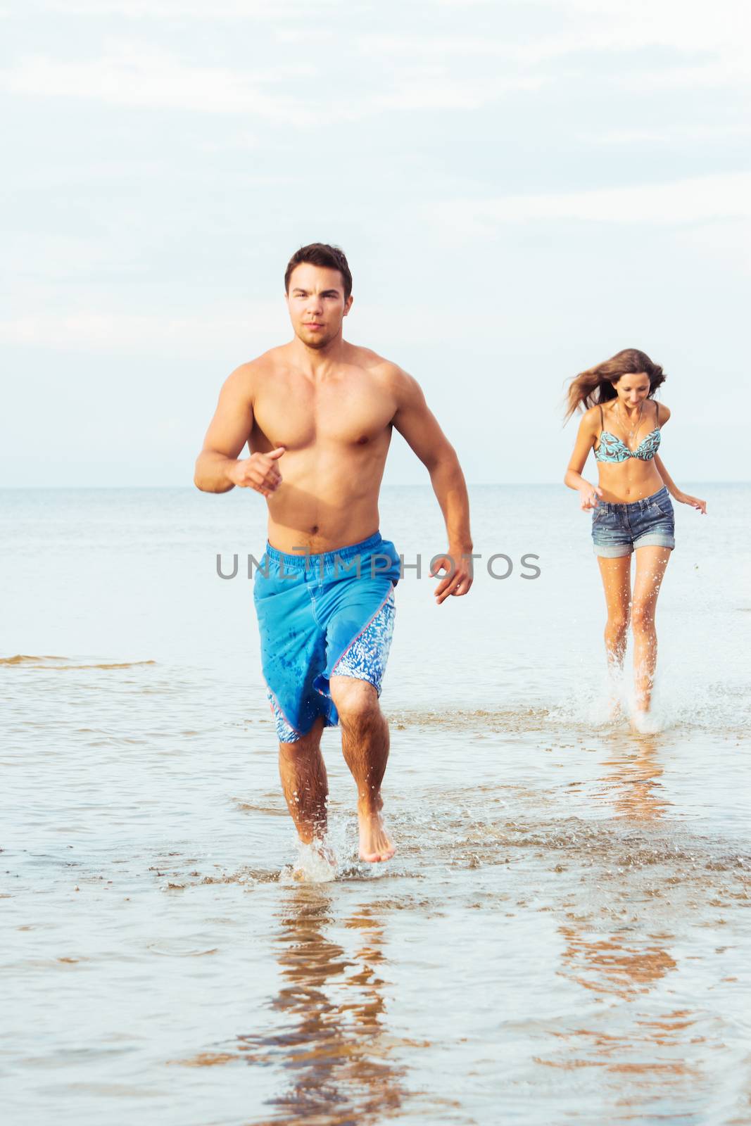 Summer, sea. Attractive couple on the beach