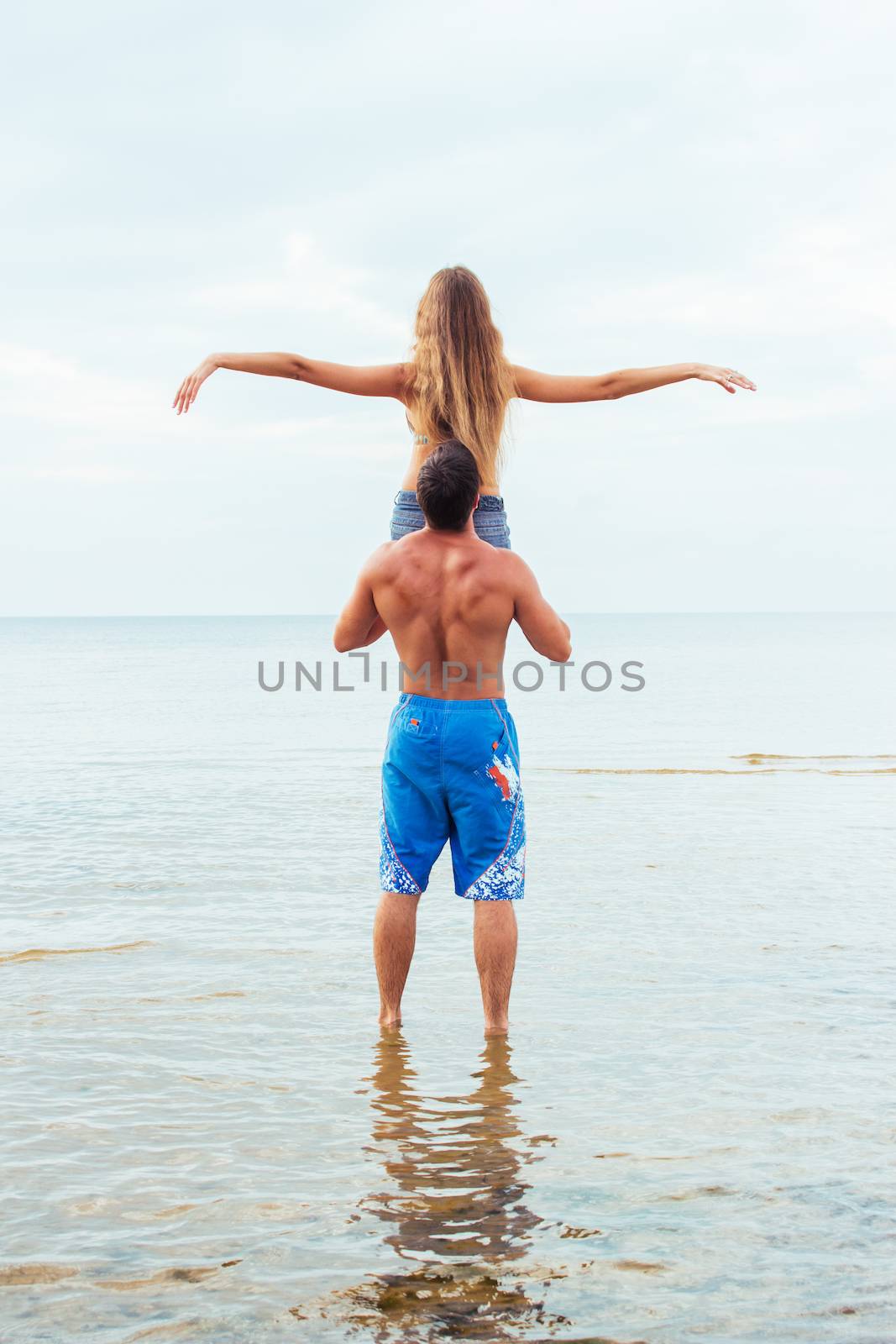 Summer, sea. Attractive couple on the beach