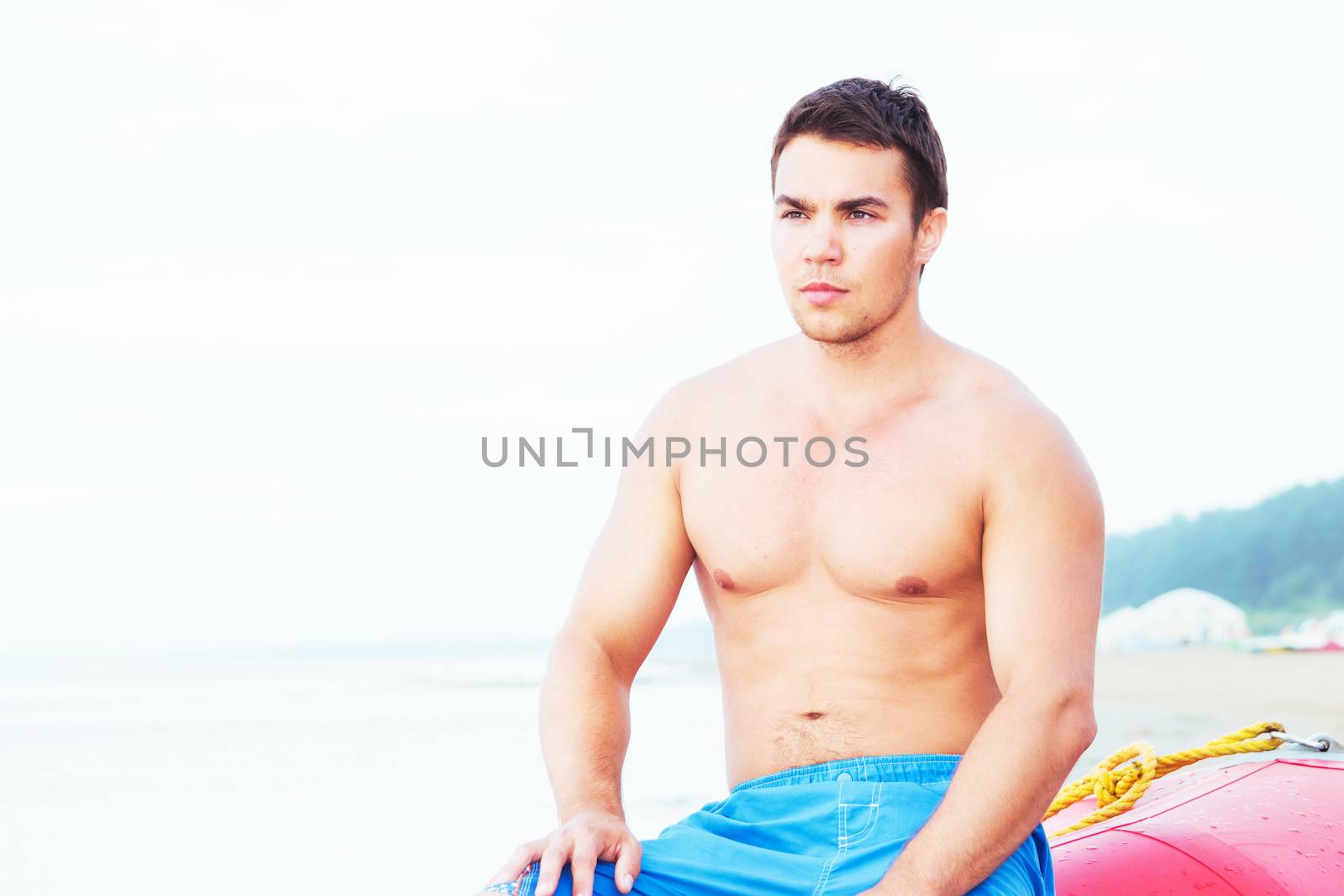 Lifeguard, summer. Handsome man on the beach