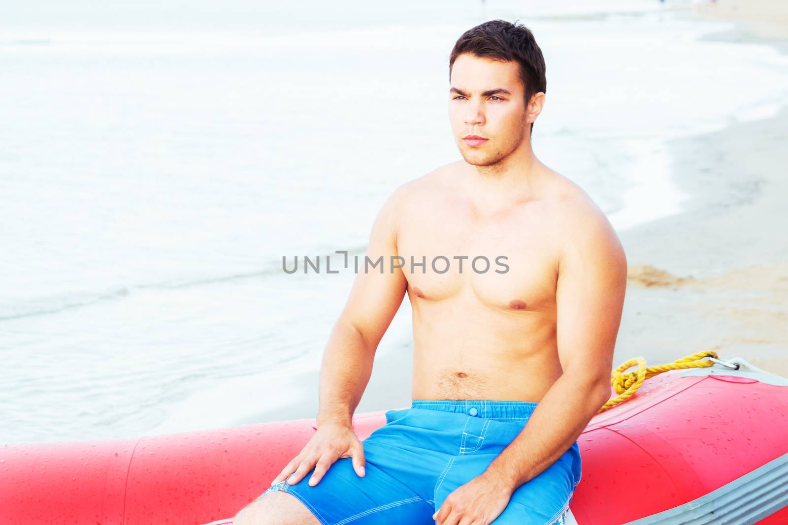 Lifeguard, summer. Handsome man on the beach