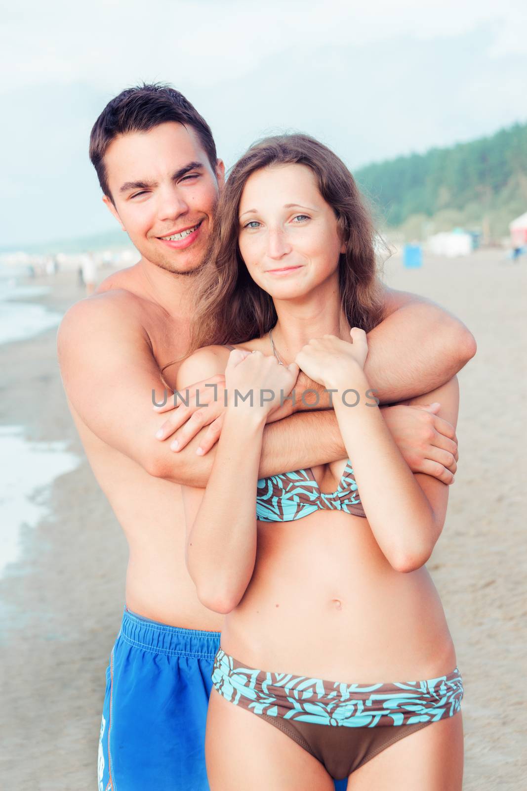 Summer, sea. Attractive couple on the beach