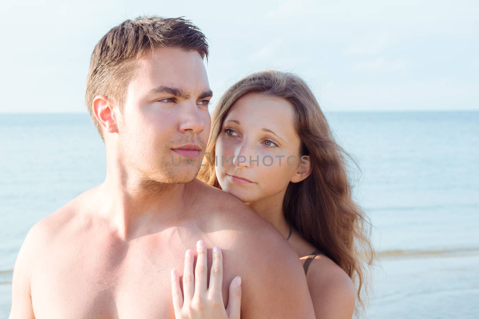 Summer, sea. Attractive couple on the beach