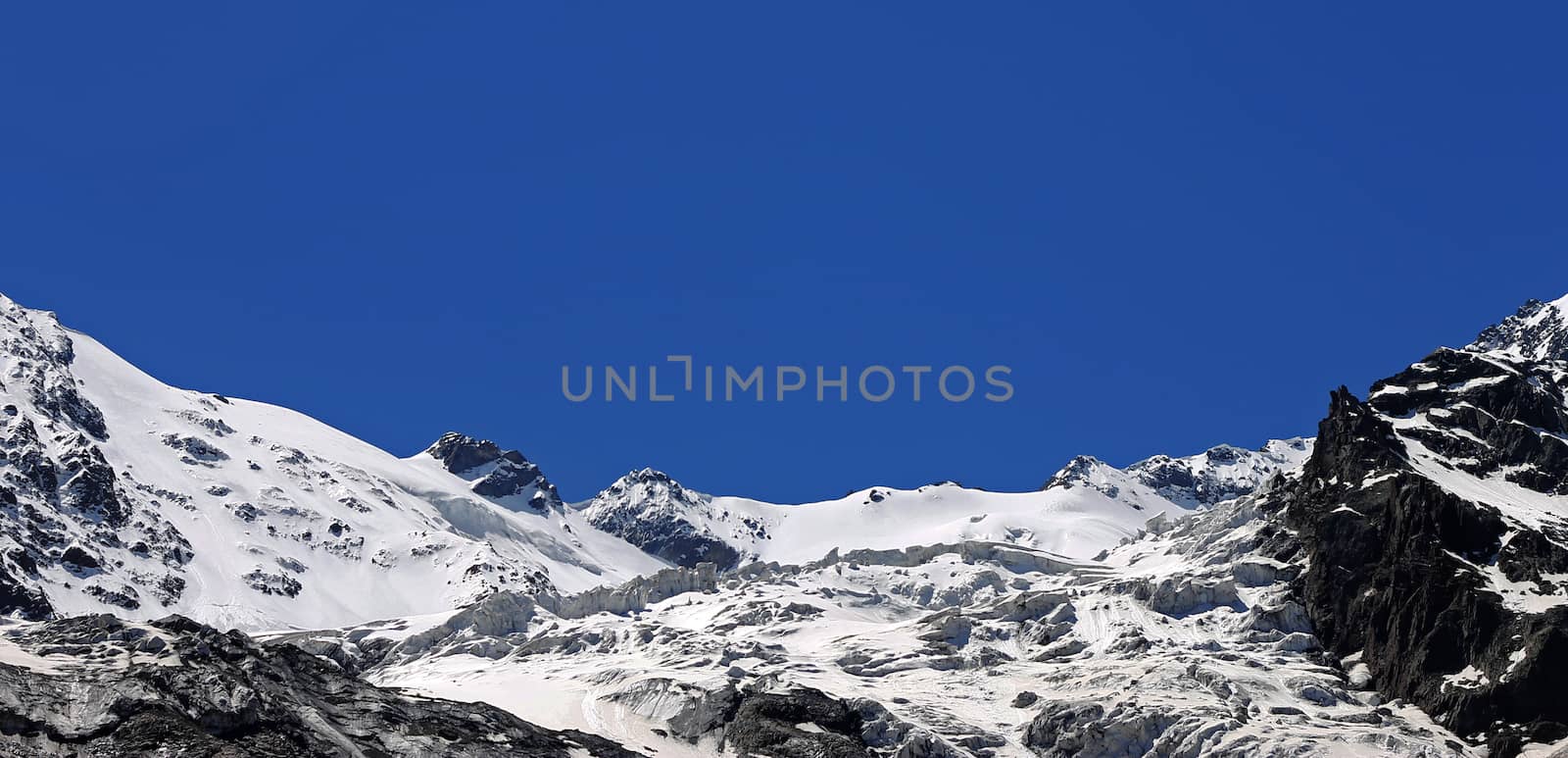 Caucasus mountains under snow and clear blue sky