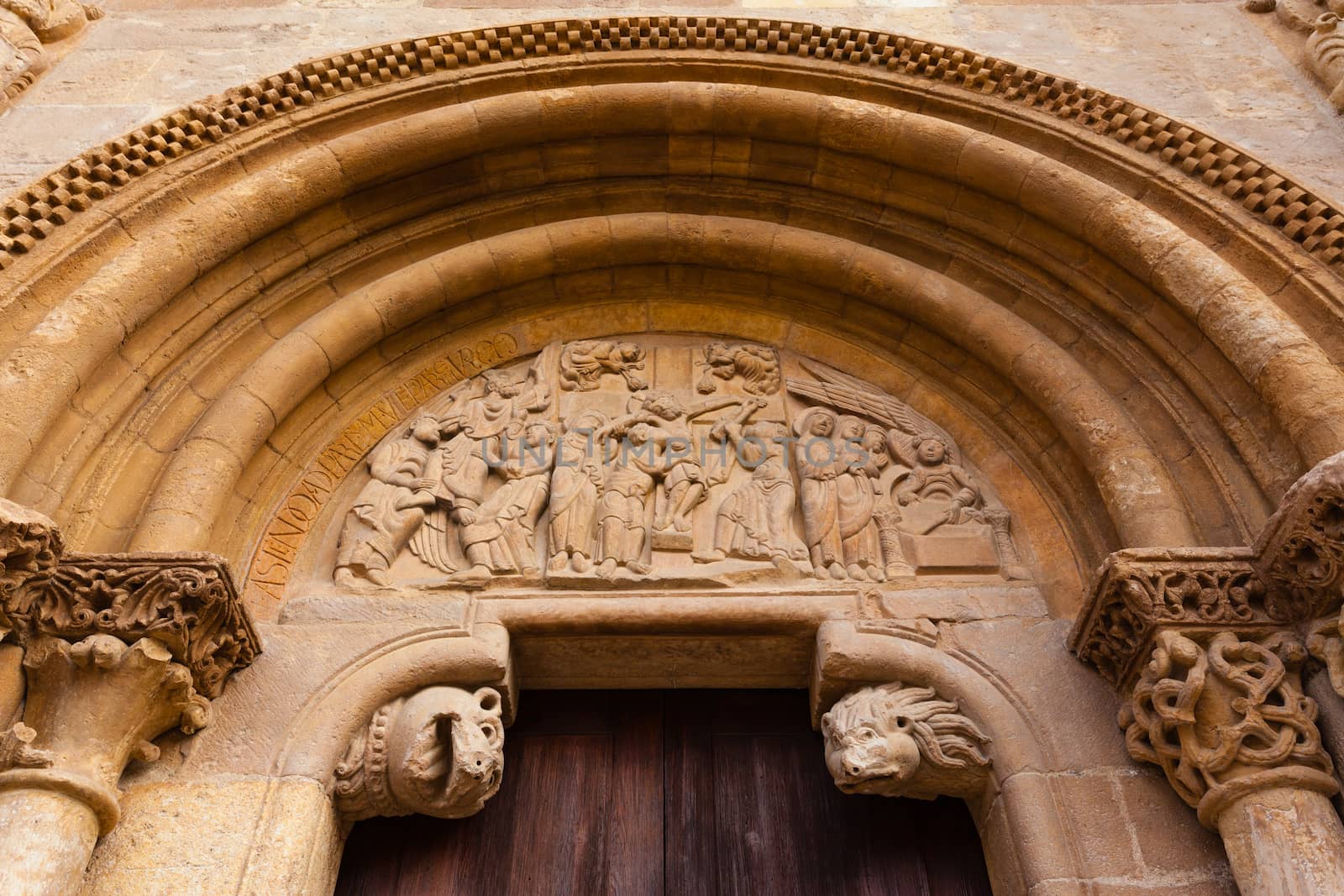 Carved tympanum  detail view of the romanesque style door  called Puerta del Cordero in the Royal San Isidoro collegiate church from the X century i n Leon Spain