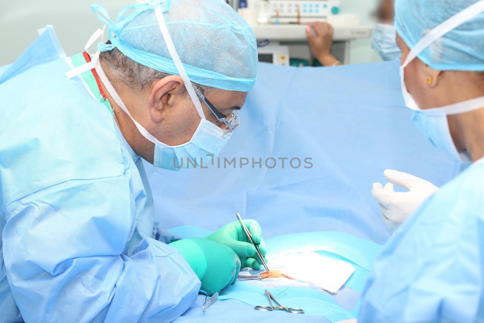 Doctor making a suture in operation room by dacasdo
